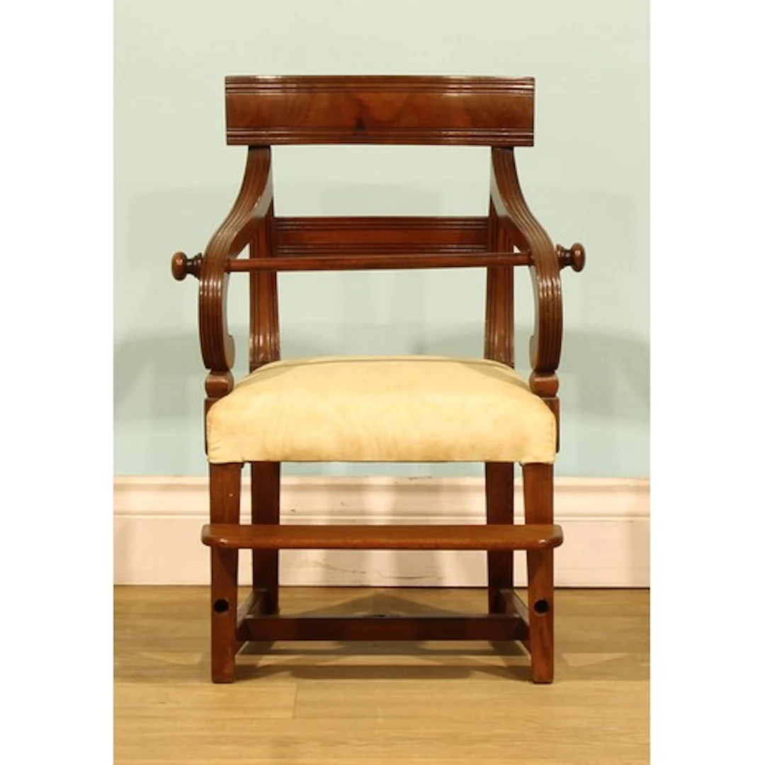 A George IV mahogany child’s chair, reeded back and arms, he...
