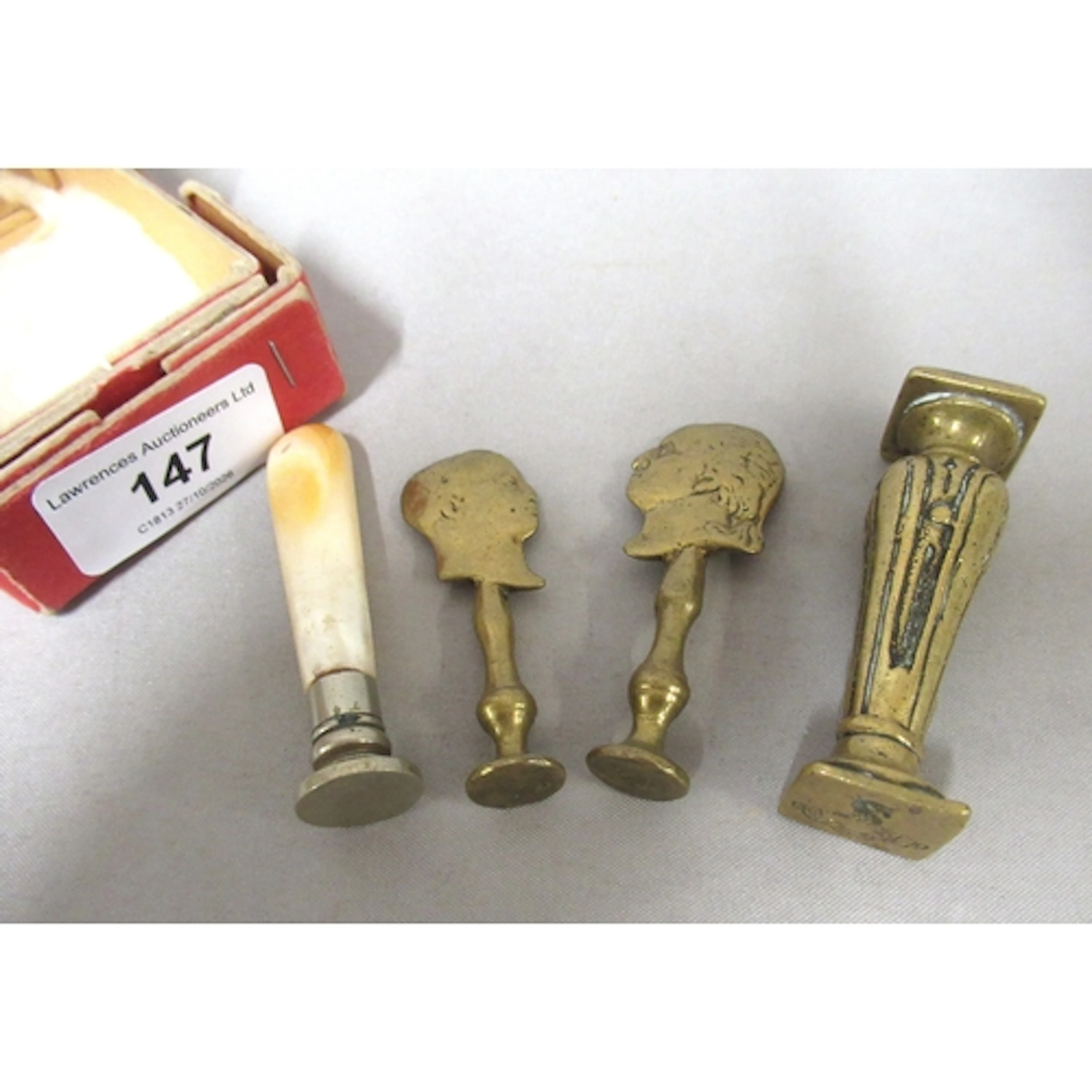 Two antique brass seals, the handles in the form of silhouet...