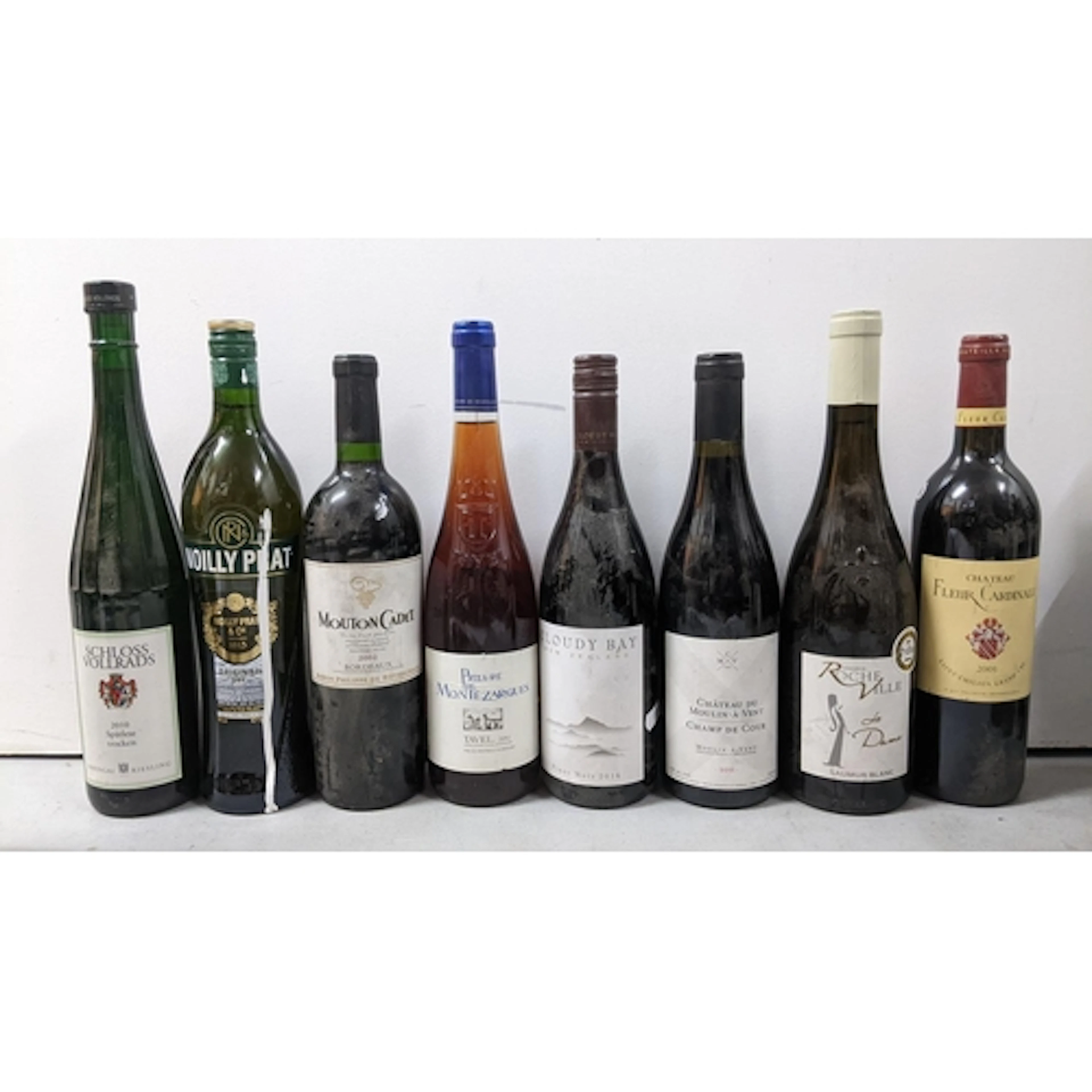 A mixed group of eigut bottles of assorted wines and aperiti...