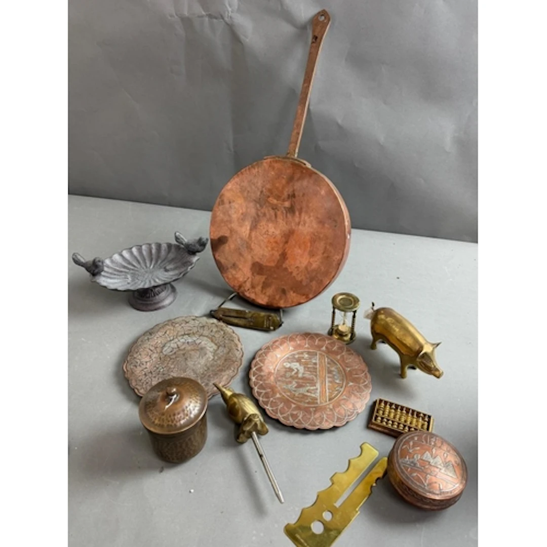 A selection of copper and brass items including pans and pla...