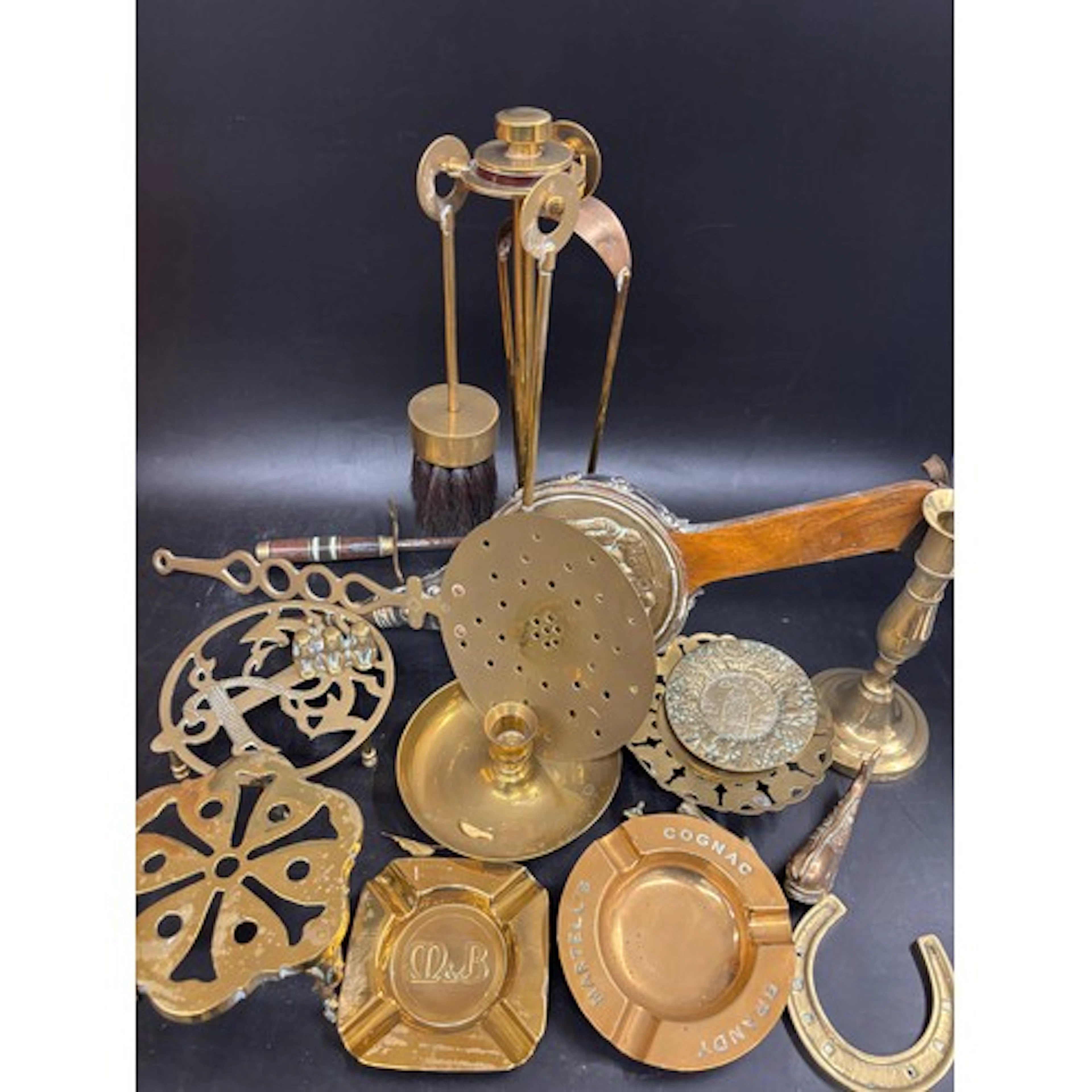 A collection of brass including two advertising ashtrays, ca...