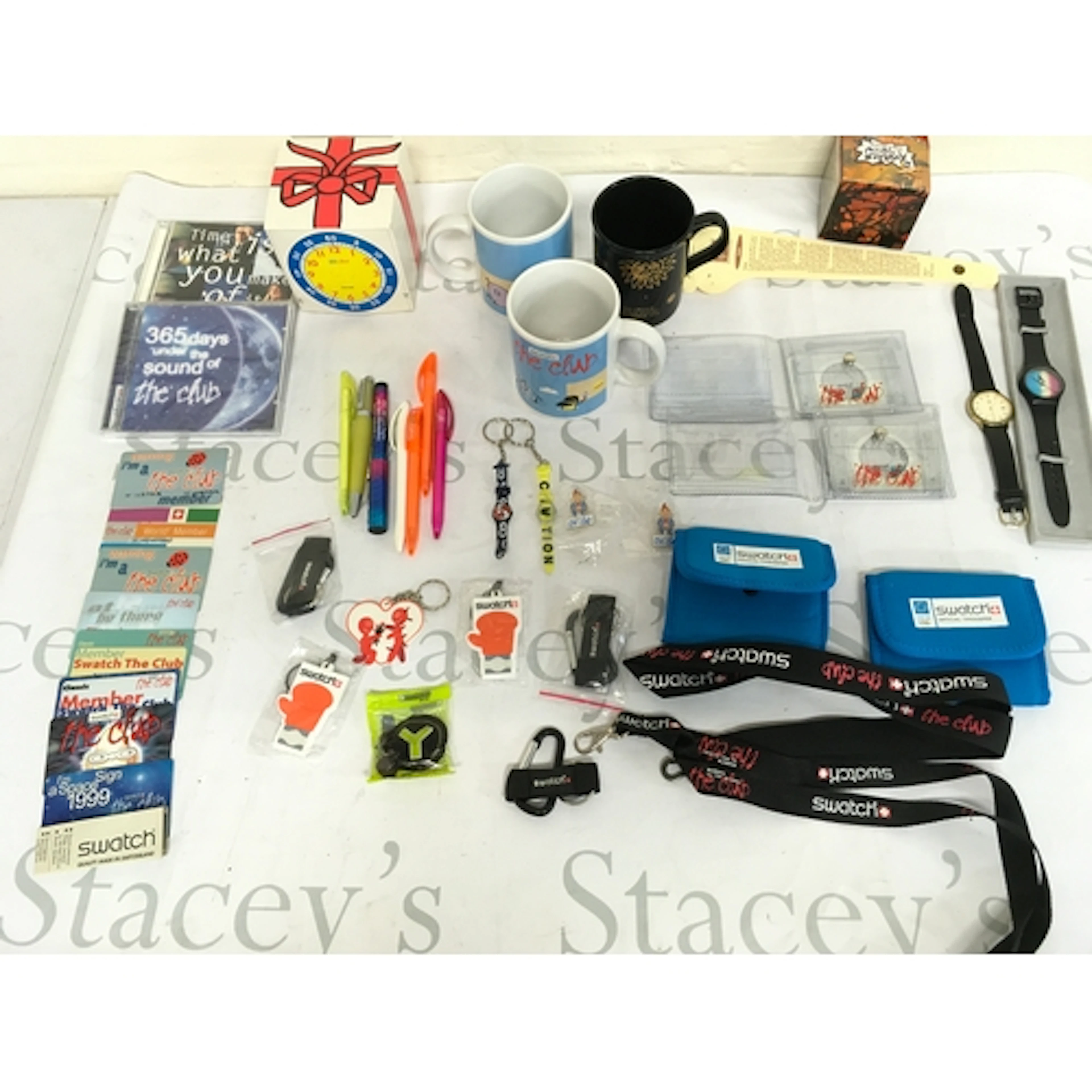 An assortment of swatch cups , pins , membership cards, wall...