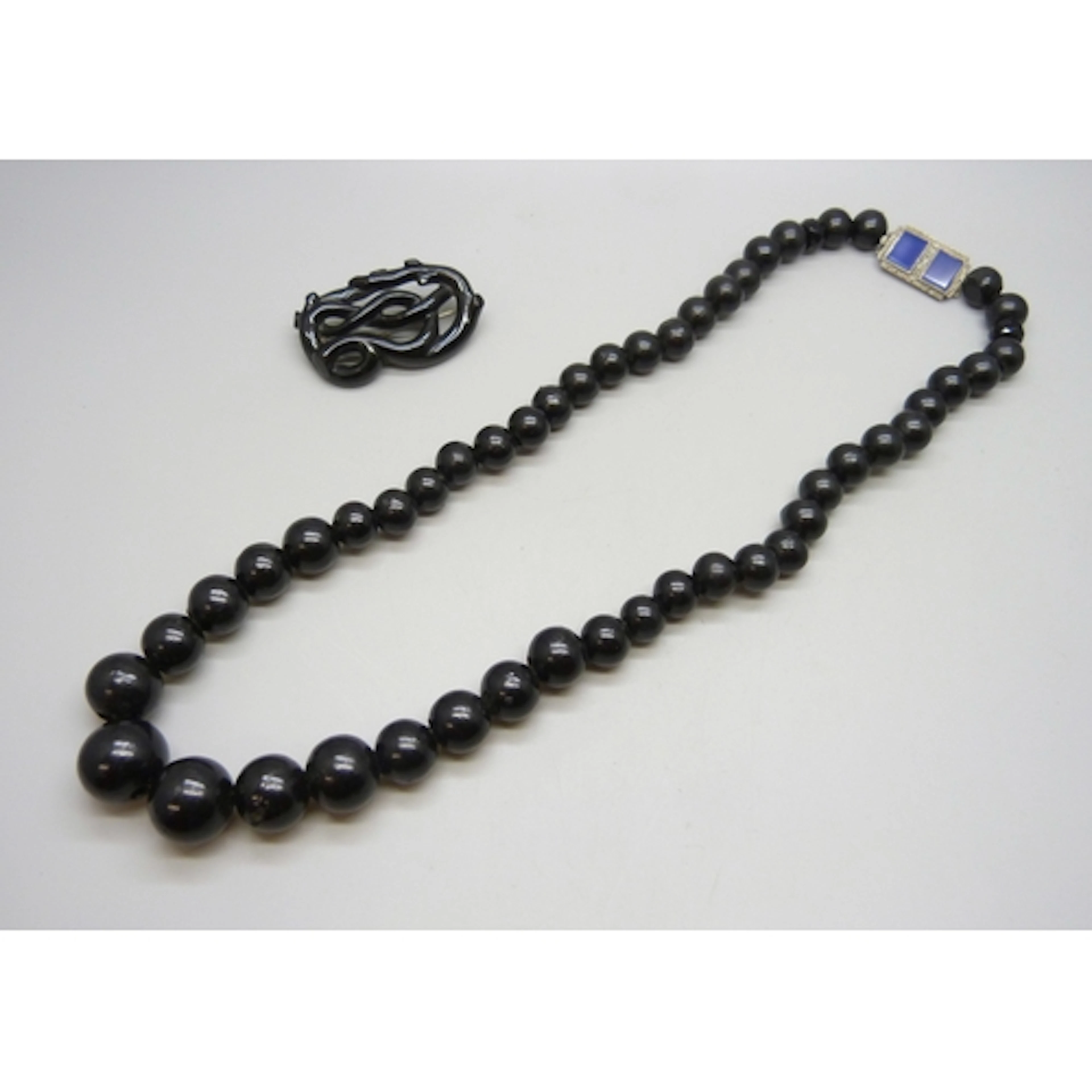 A jet necklace with a silver, chalcedony and marcasite clasp...