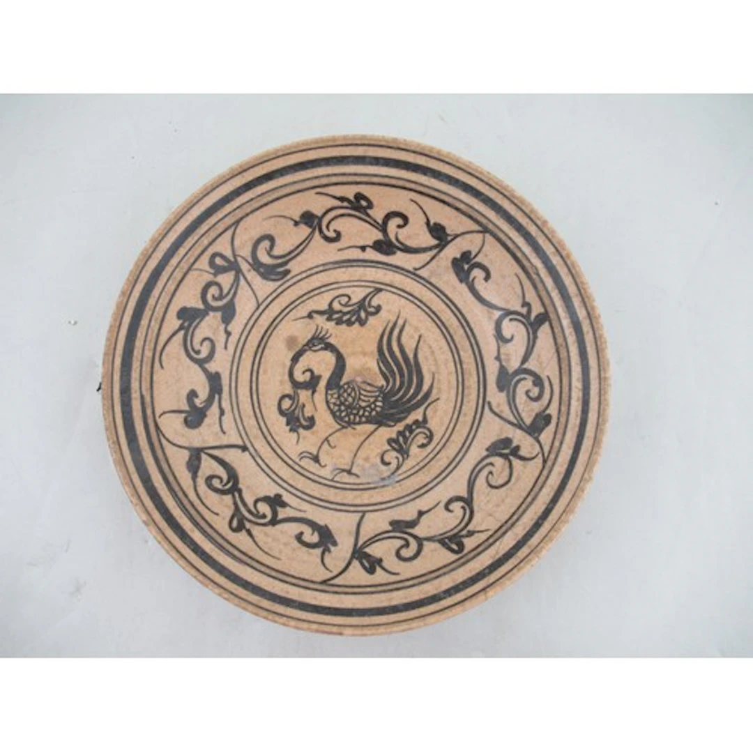 A Vietnamese pottery dish, decorated with a bird to the cent...