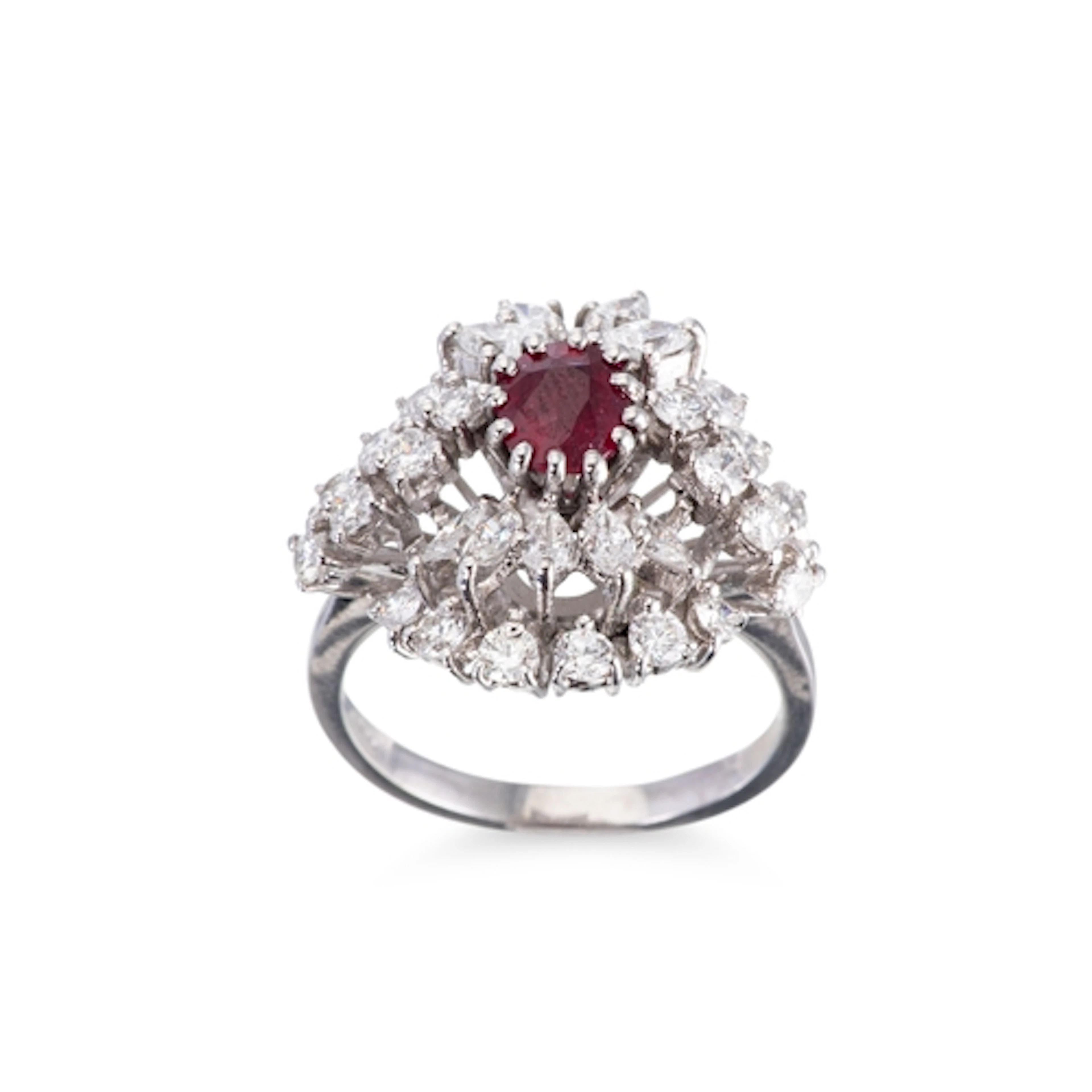 A RUBY AND DIAMOND SET CLUSTER RING, the central ruby to mar...