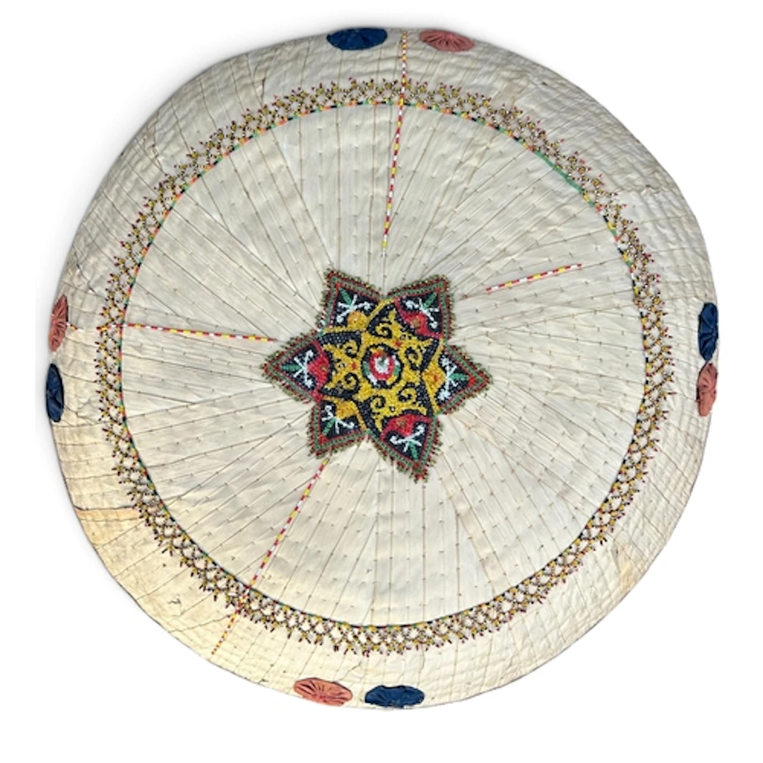 AN EARLY 20TH CENTURY TRIBAL DAYAK PALM LEAF AND CANE SUN HA...