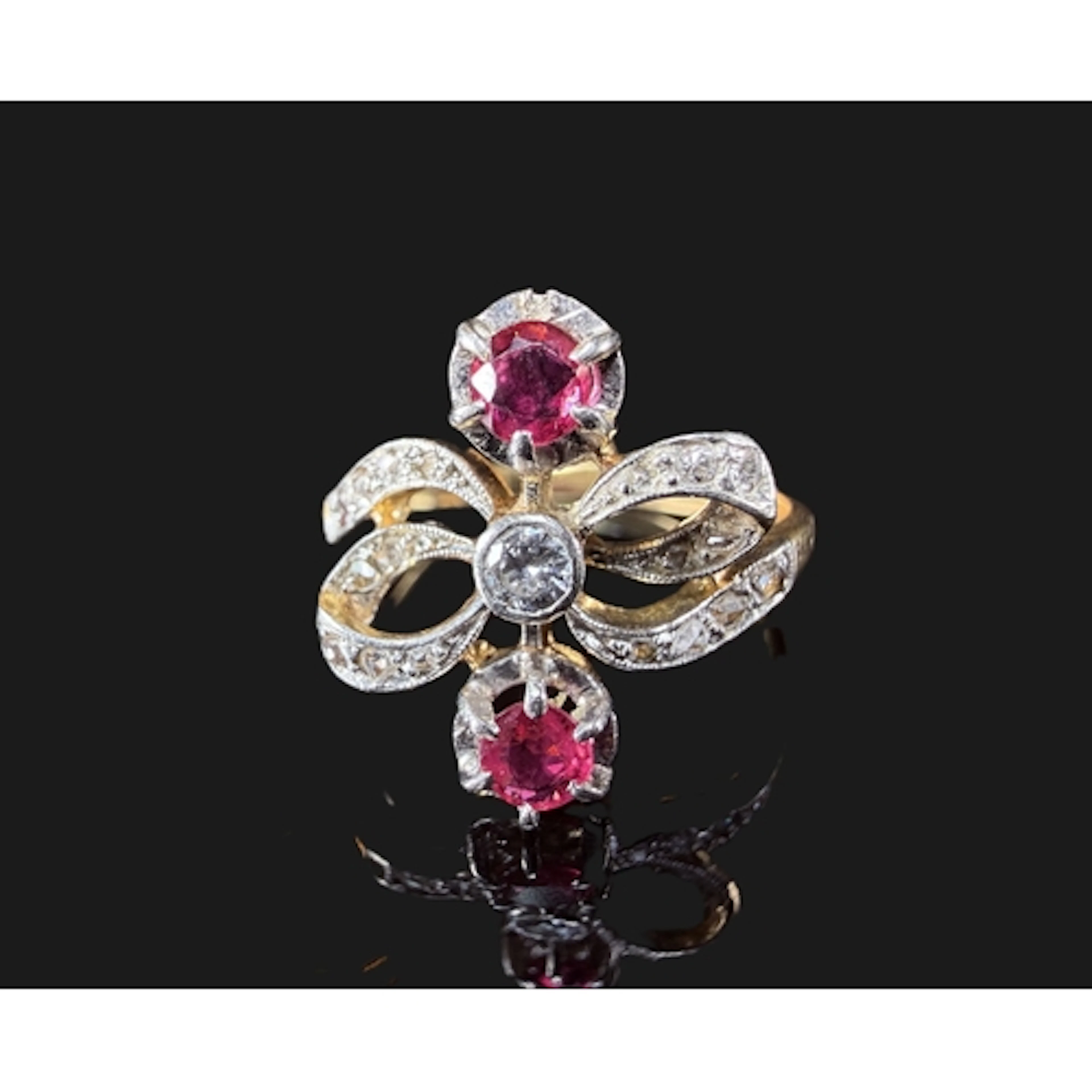A yellow metal dress ring in bow design set rose and old cut...