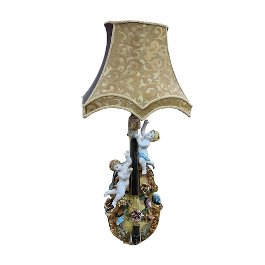 An Italian Capodimonte floral encrusted 'guitar' lamp with s...