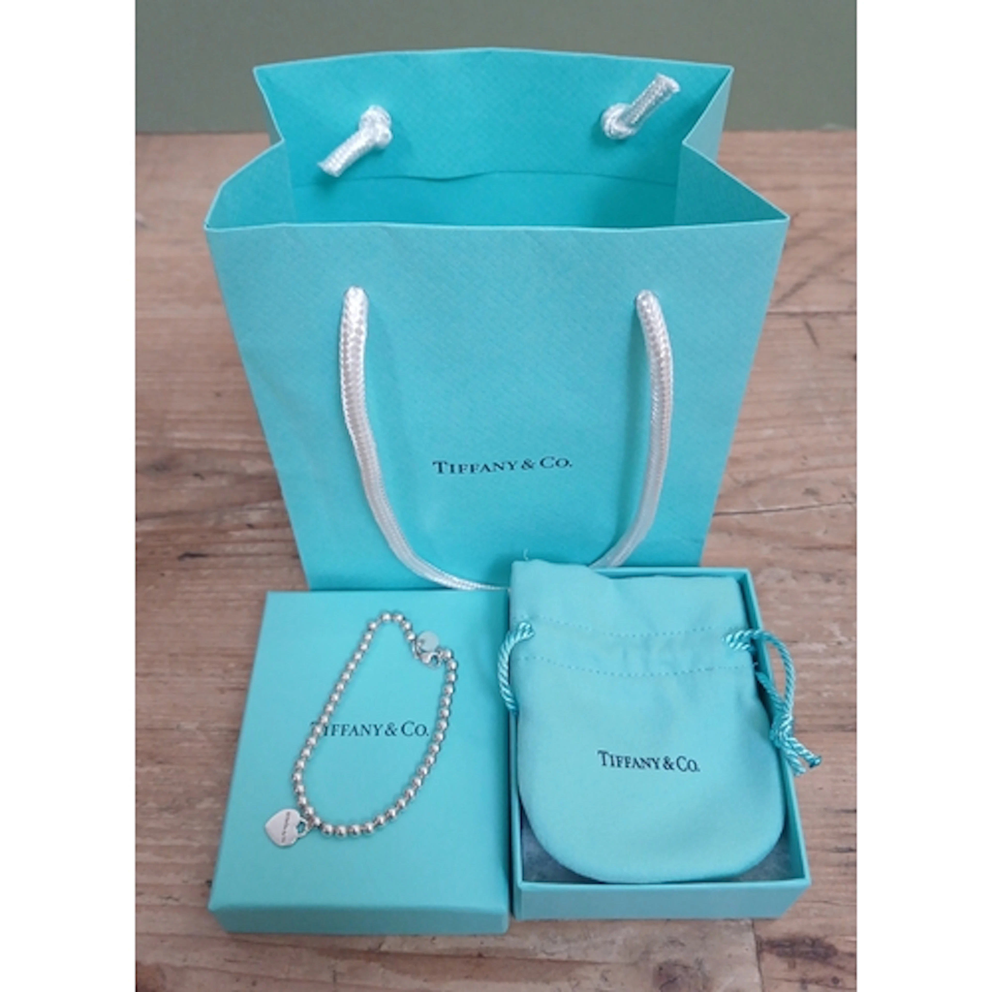 TIFFANY & CO, a sterling silver bead bracelet with Please Re...