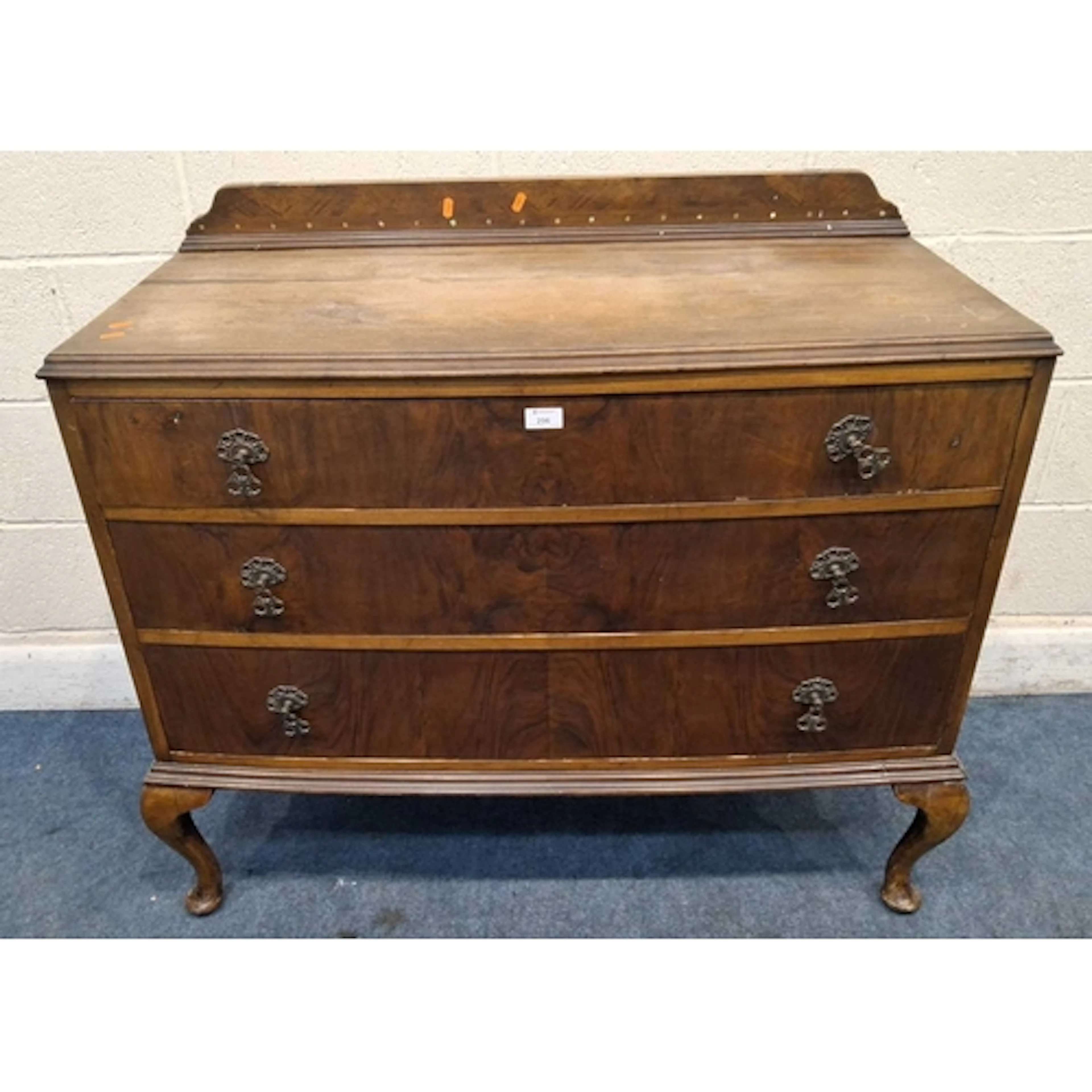 AN EARLY 20TH CENTURY BOW FRONT CHEST OF THREE LONG DRAWERS,...