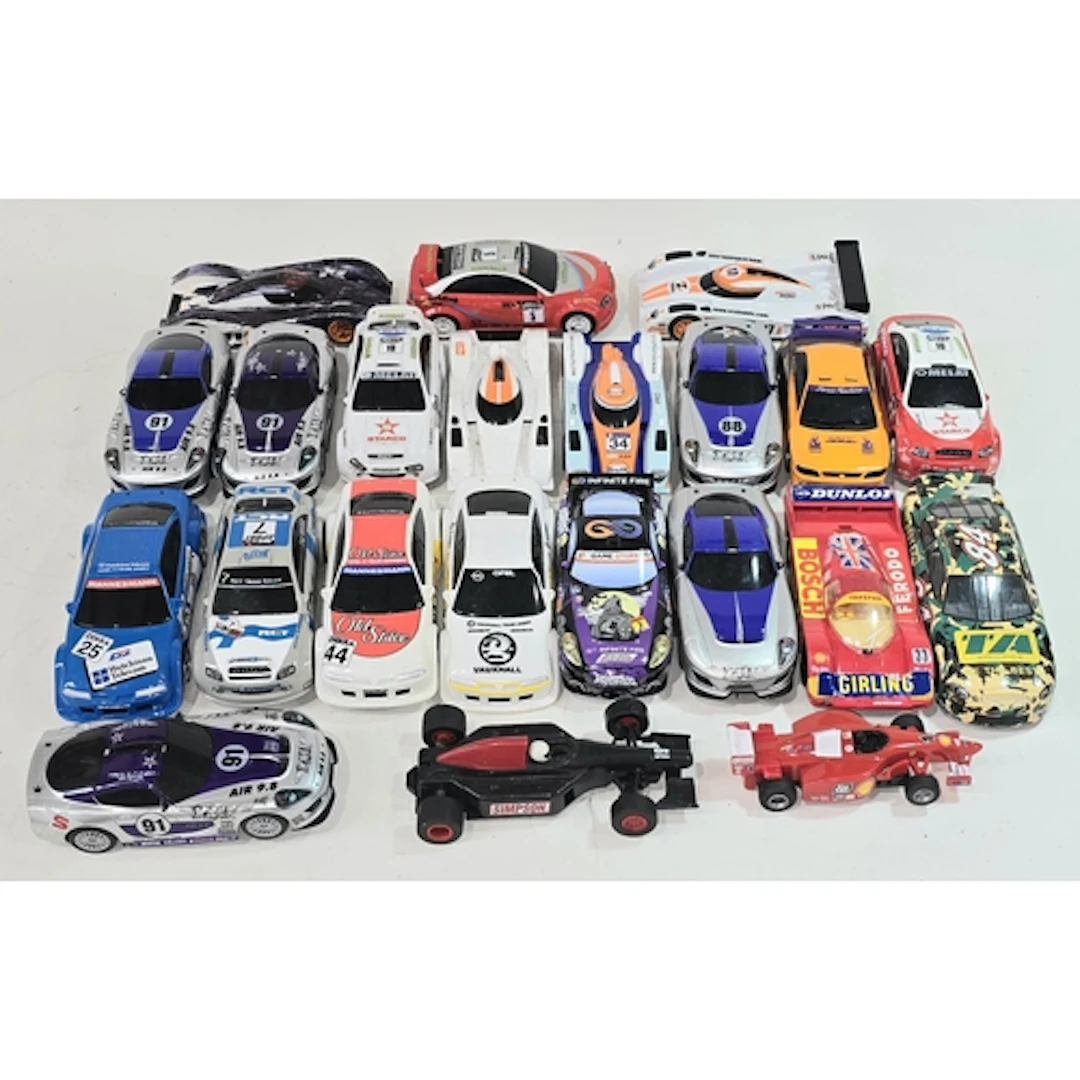 A box containing a good quantity of Scalextric cars.