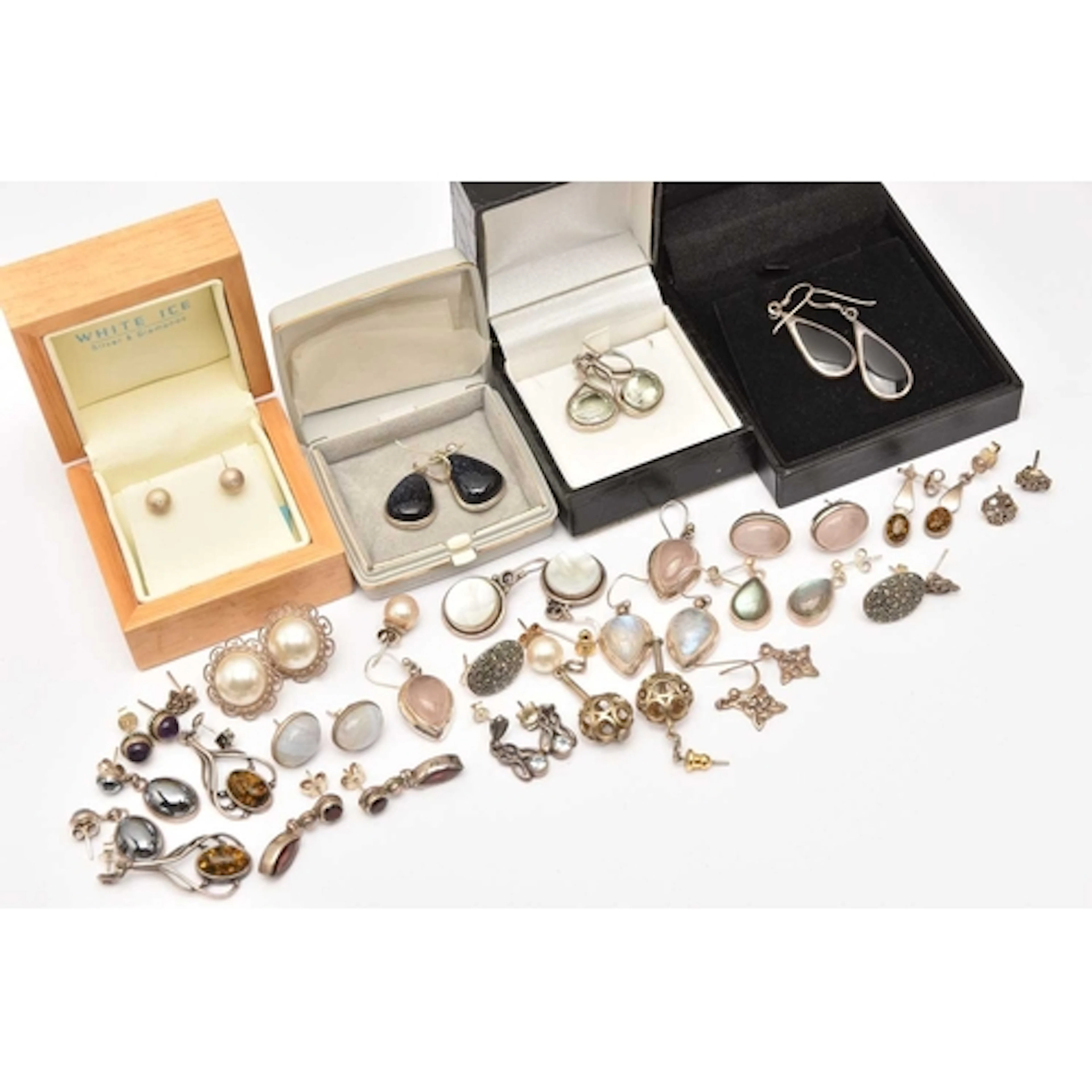AN ASSORTMENT OF WHITE METAL EARRINGS, mostly set with semi-...