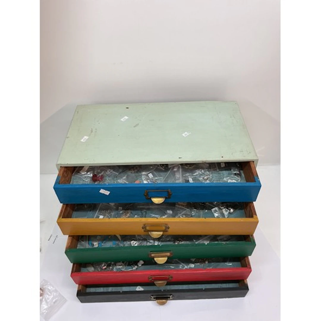 A wooden drawer unit containing modern white metal 925 dress...