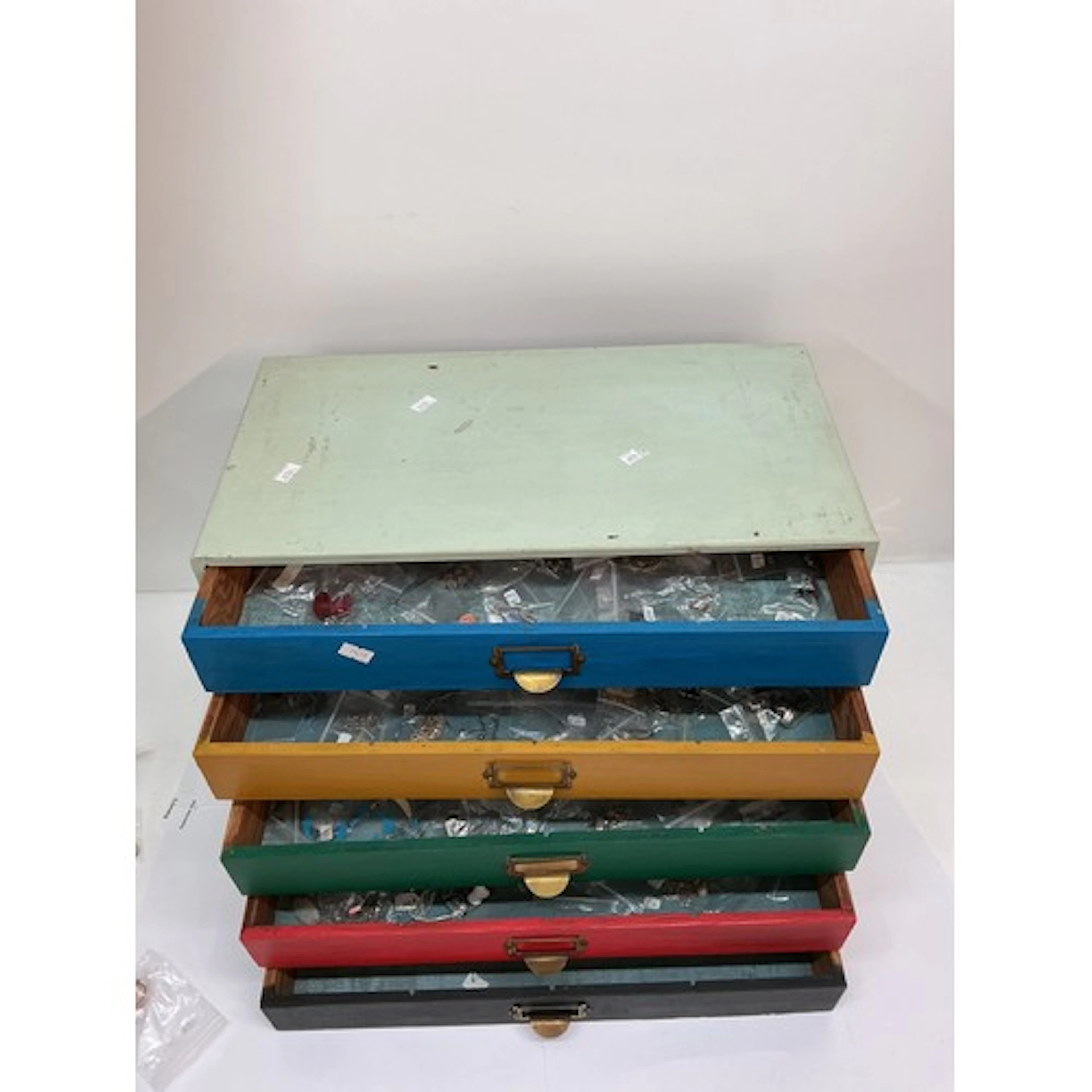 A wooden drawer unit containing modern white metal 925 dress...