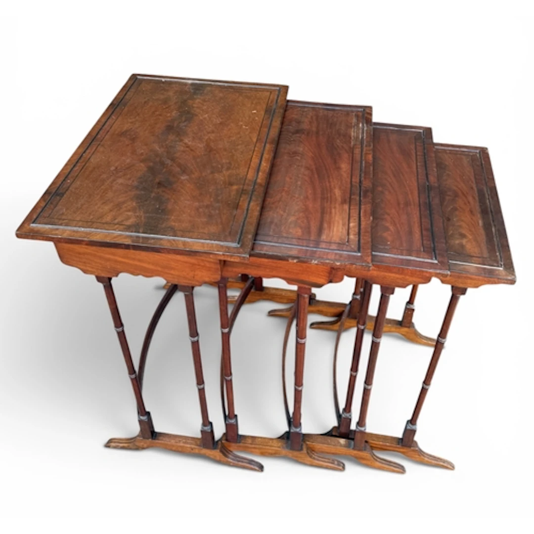 A MAHOGANY NEST OF FOUR TABLES 70cm x 49cm x 45cm for the la...