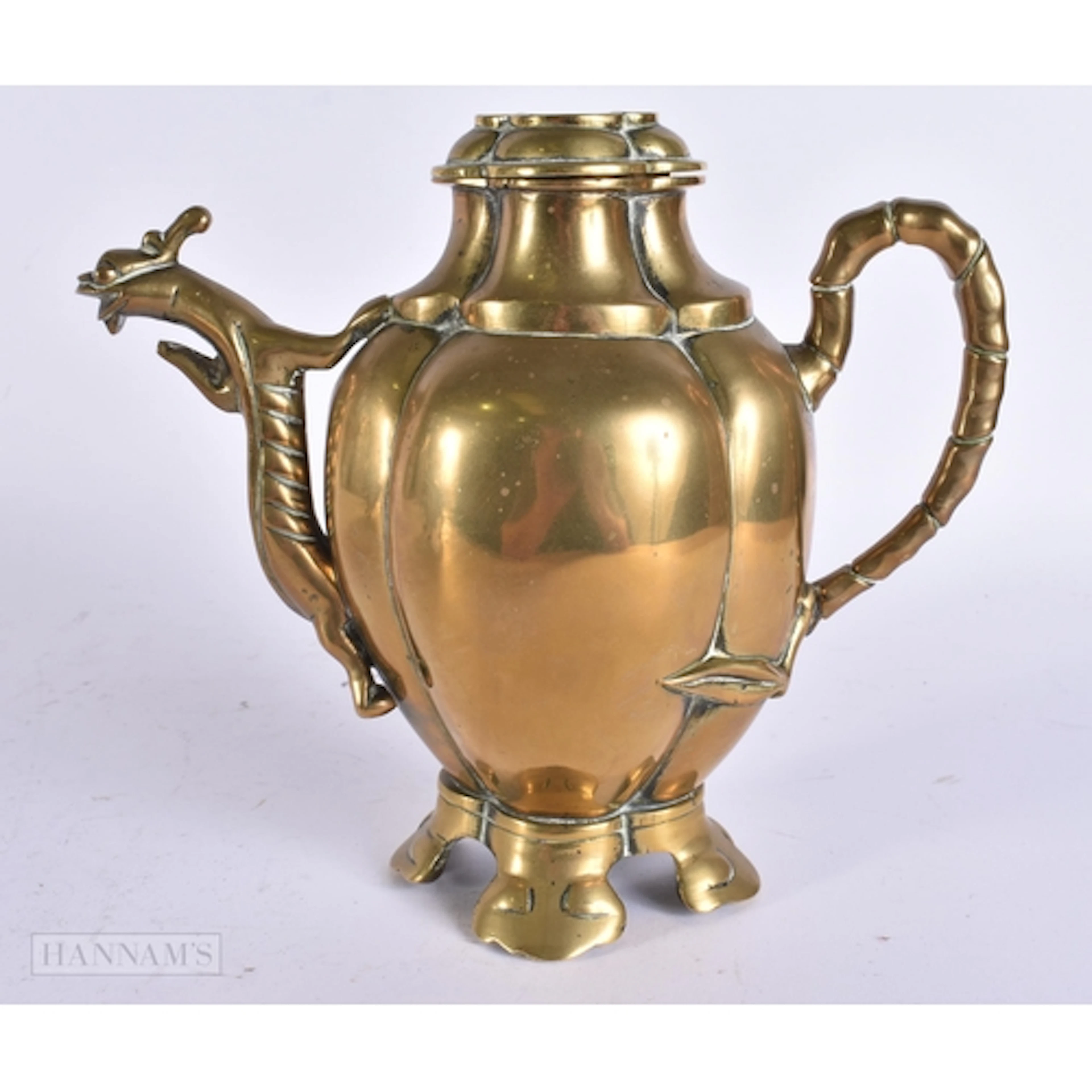 A CHINESE QING DYNASTY BRONZE EWER of lobed form. 18 cm x 16...