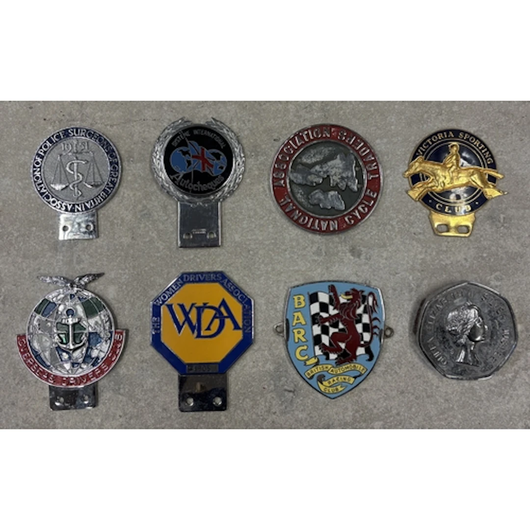 A collection of eight car badges to include Overseas Drivers...