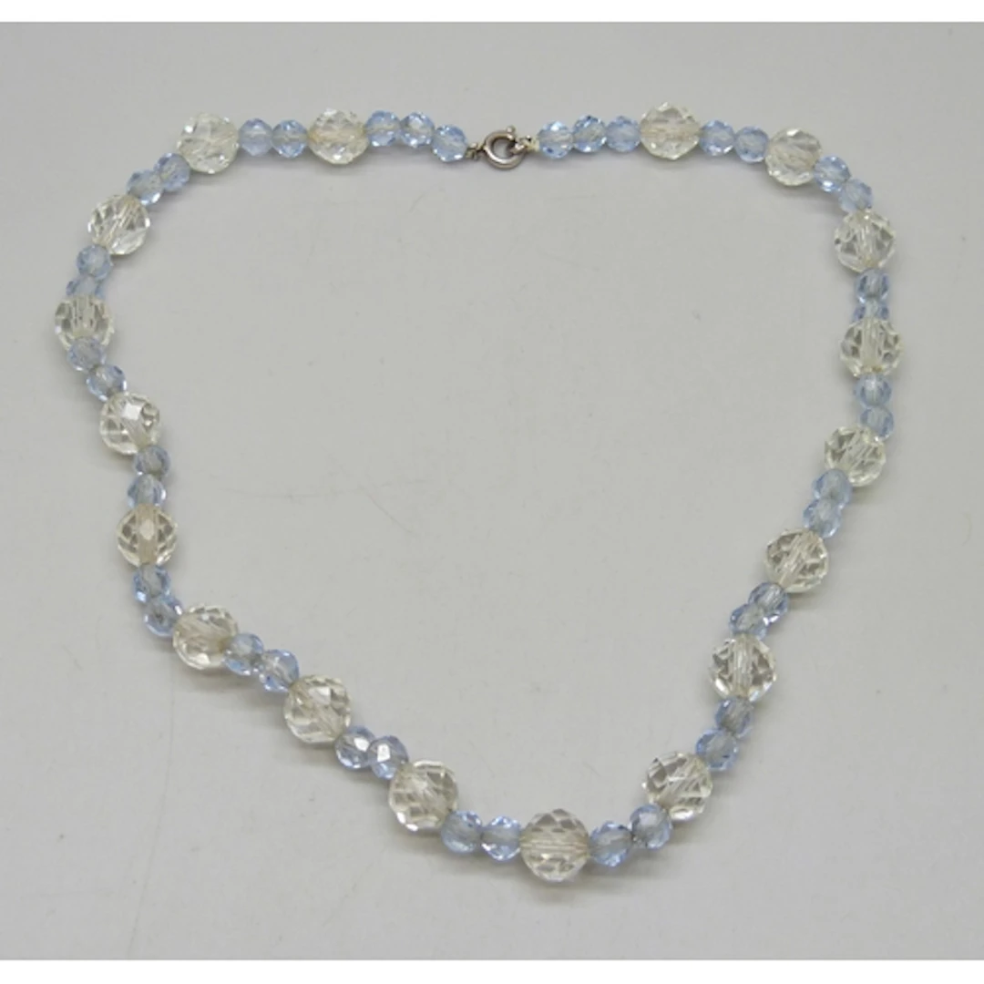 An Art Deco faceted clear and blue glass necklace, with a .9...