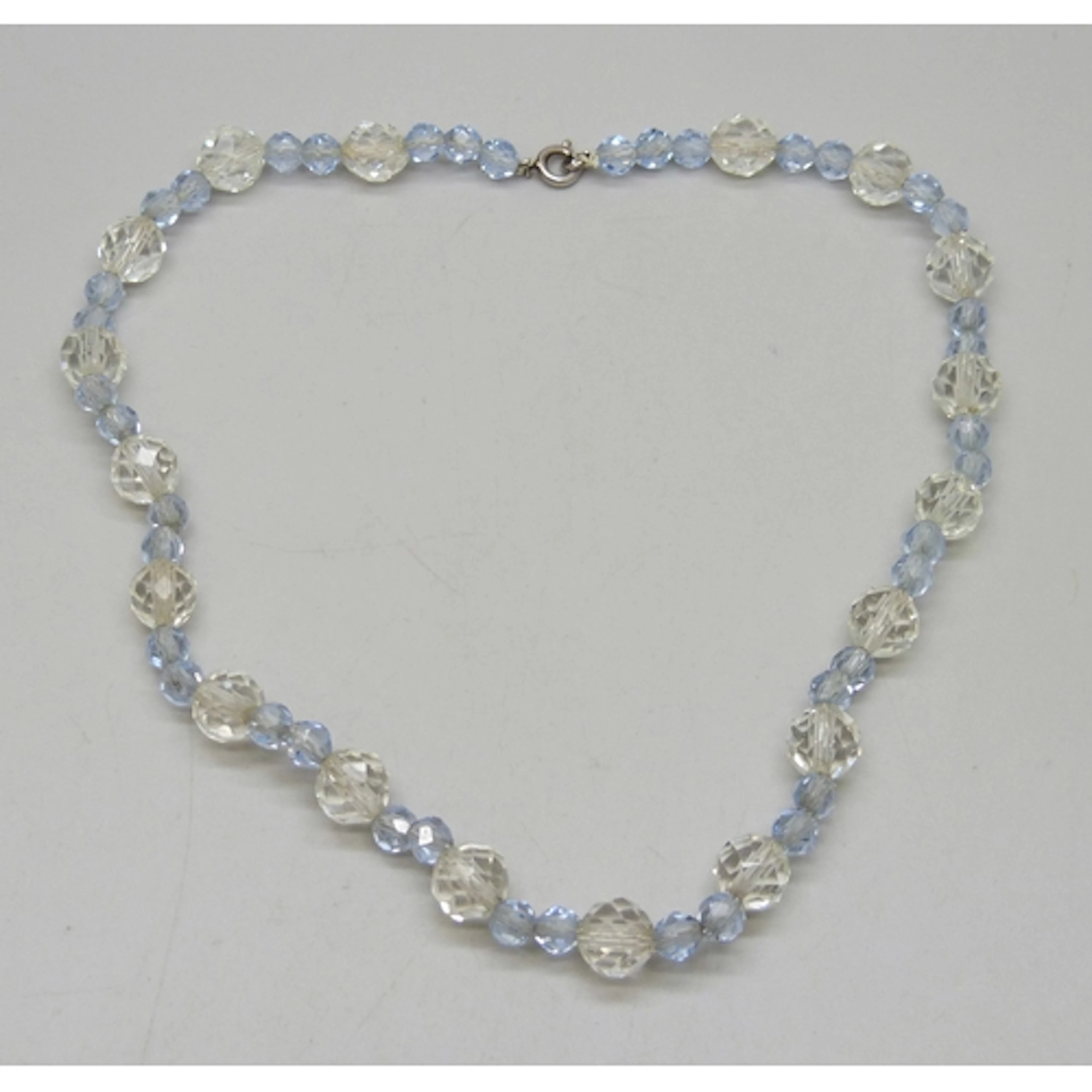 An Art Deco faceted clear and blue glass necklace, with a .9...