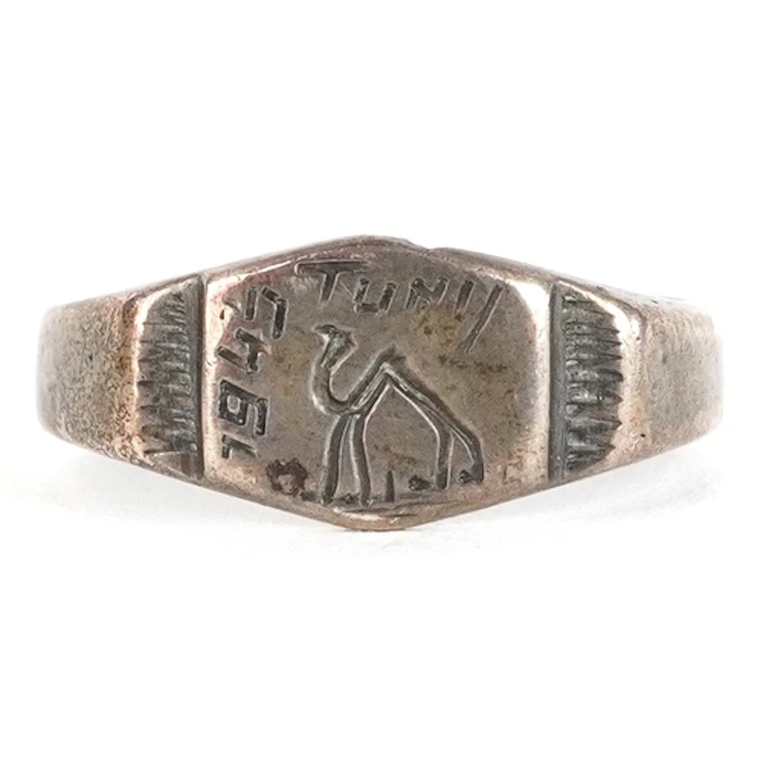 Vintage white metal signet ring engraved with a camel, dated...