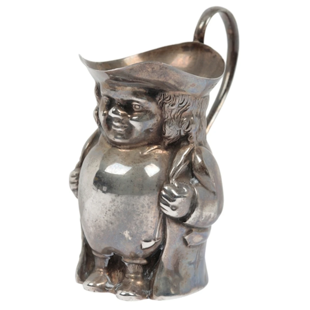 A George V novelty silver cream jug, modelled as a Toby jug,...