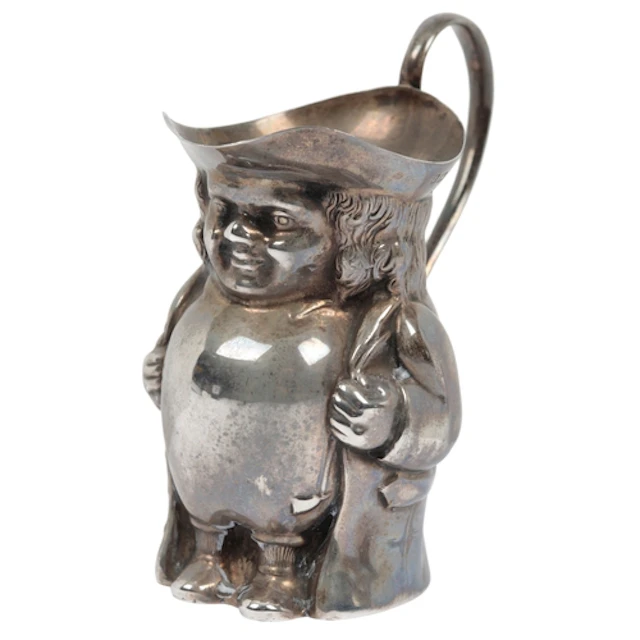 A George V novelty silver cream jug, modelled as a Toby jug,...