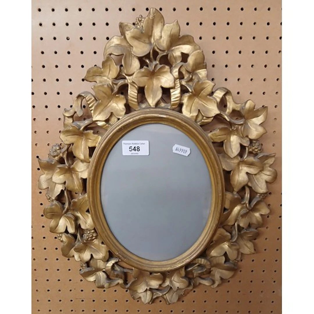 Oval floral gilt photo frame.