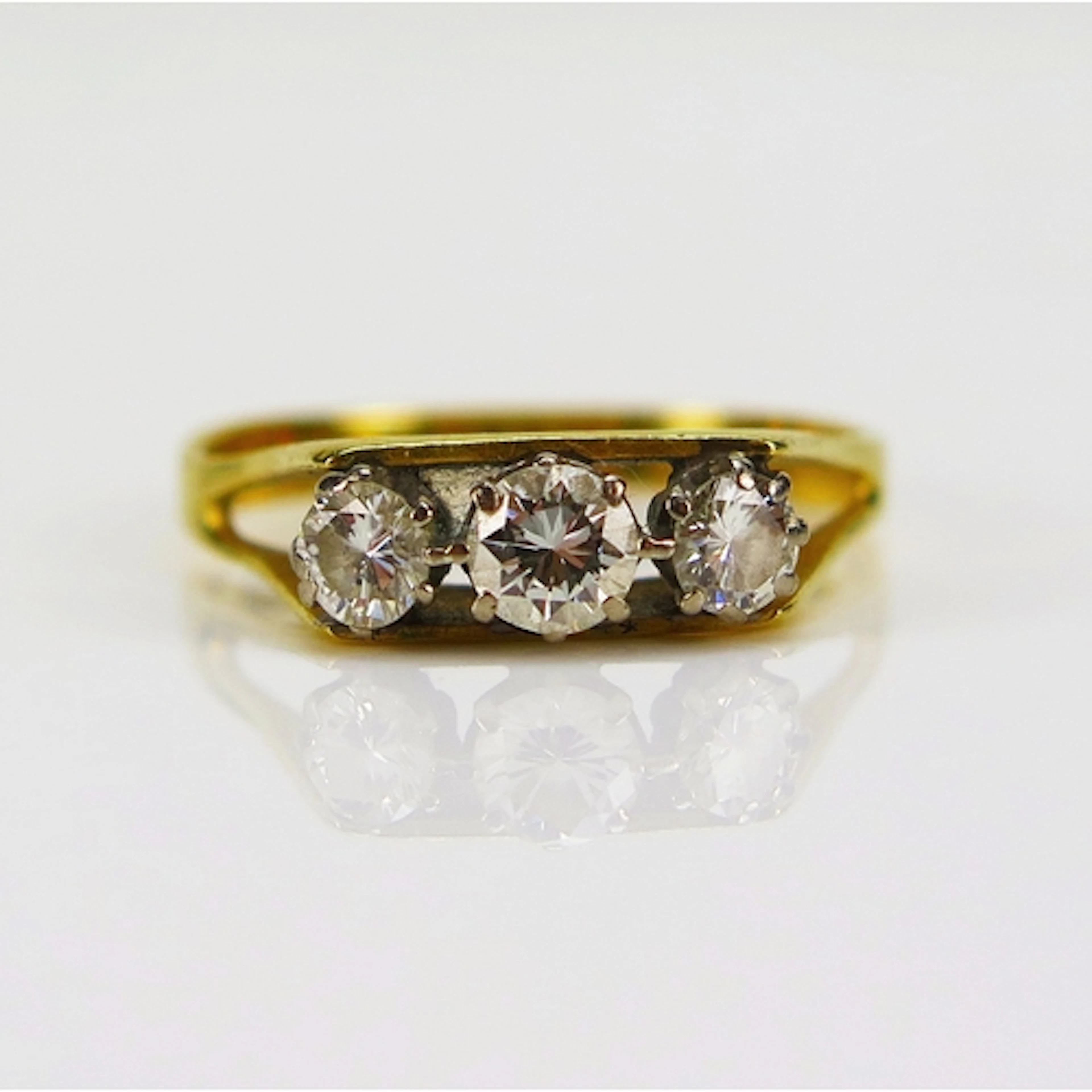 A three stone brilliant round cut diamond ring in an 18ct ye...