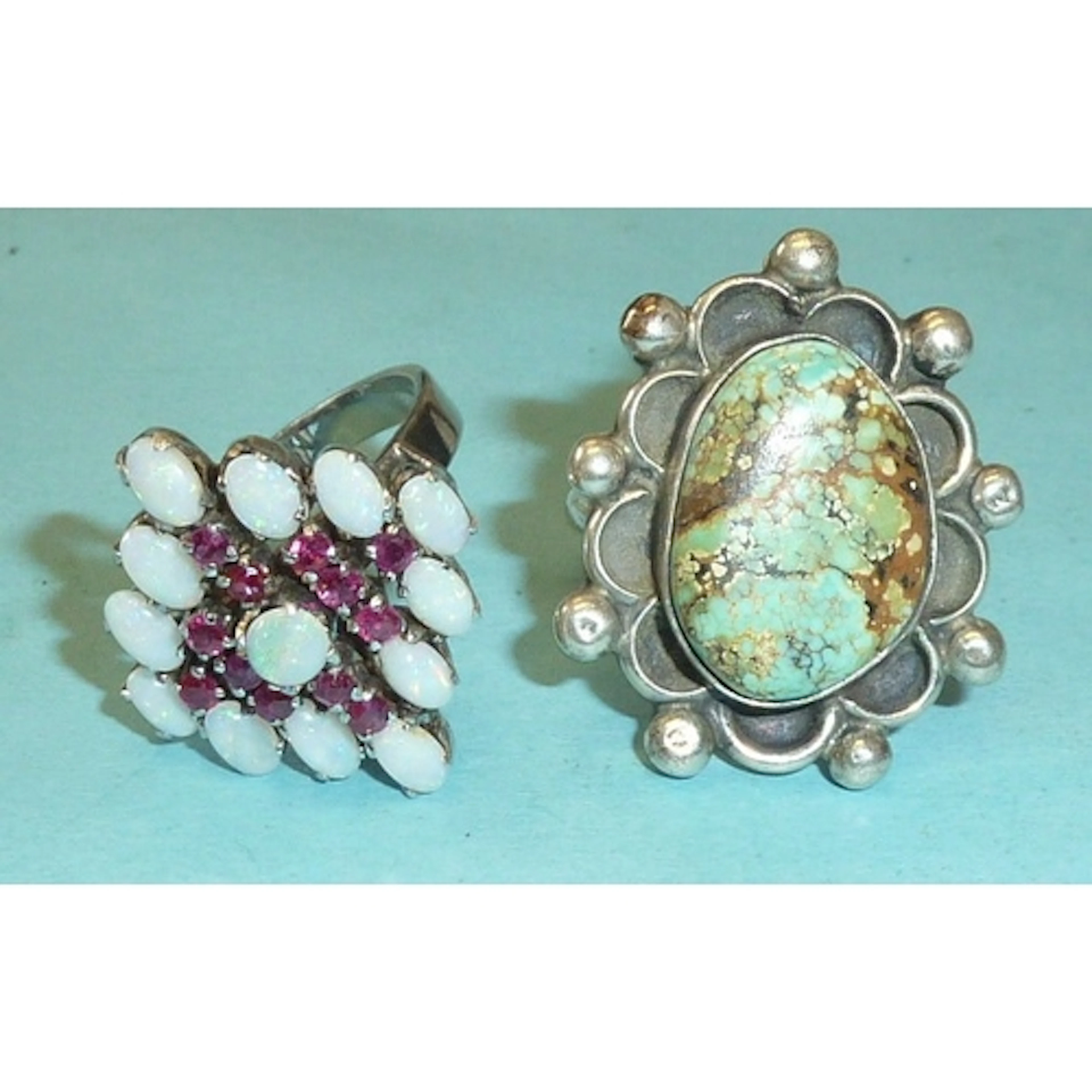 A ruby and opal ring set a cluster of twelve round-cut rubie...