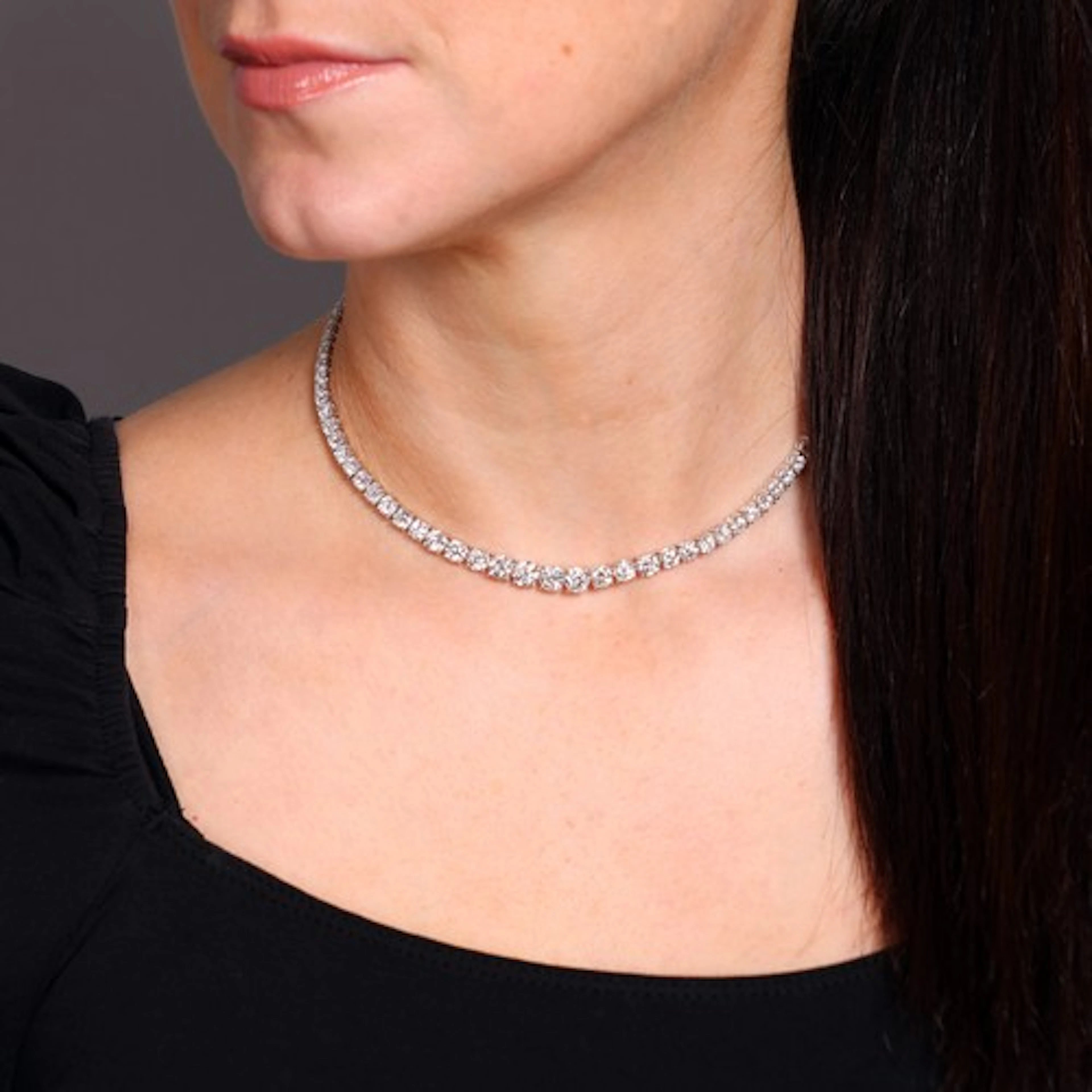 A Diamond Tennis Line Necklace, the single row set with one...