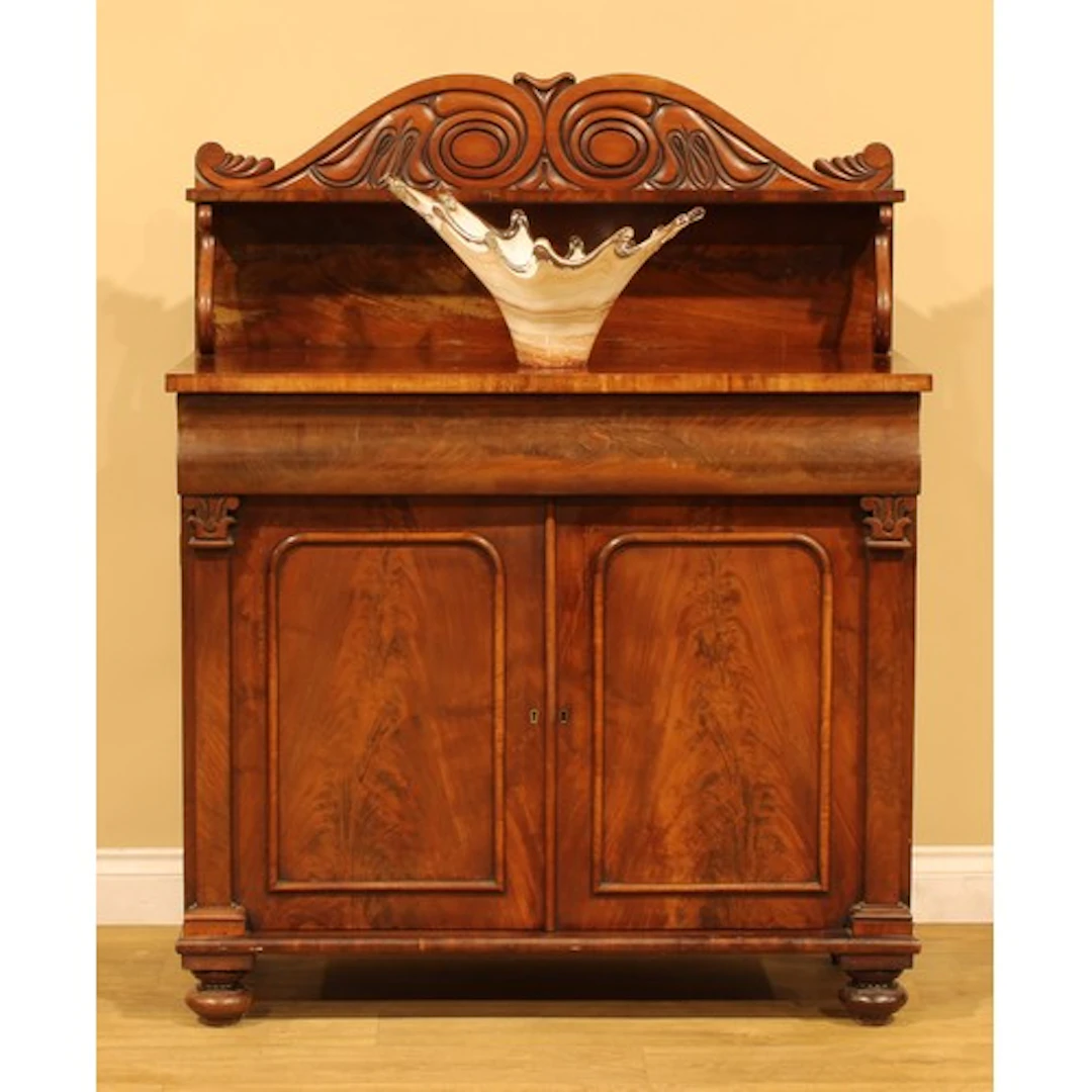A George IV flame mahogany chiffonier pier cabinet, shaped p...