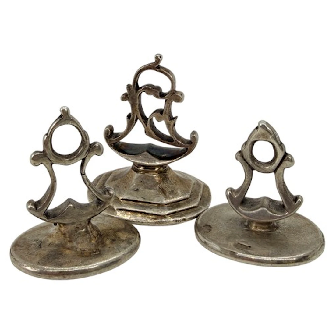 Three English silver fob seals of oval form, the first engra...