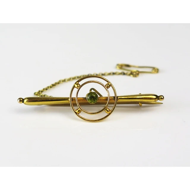 A 9ct gold and peridot bar brooch, 45mm long, stamped 9ct, 2...