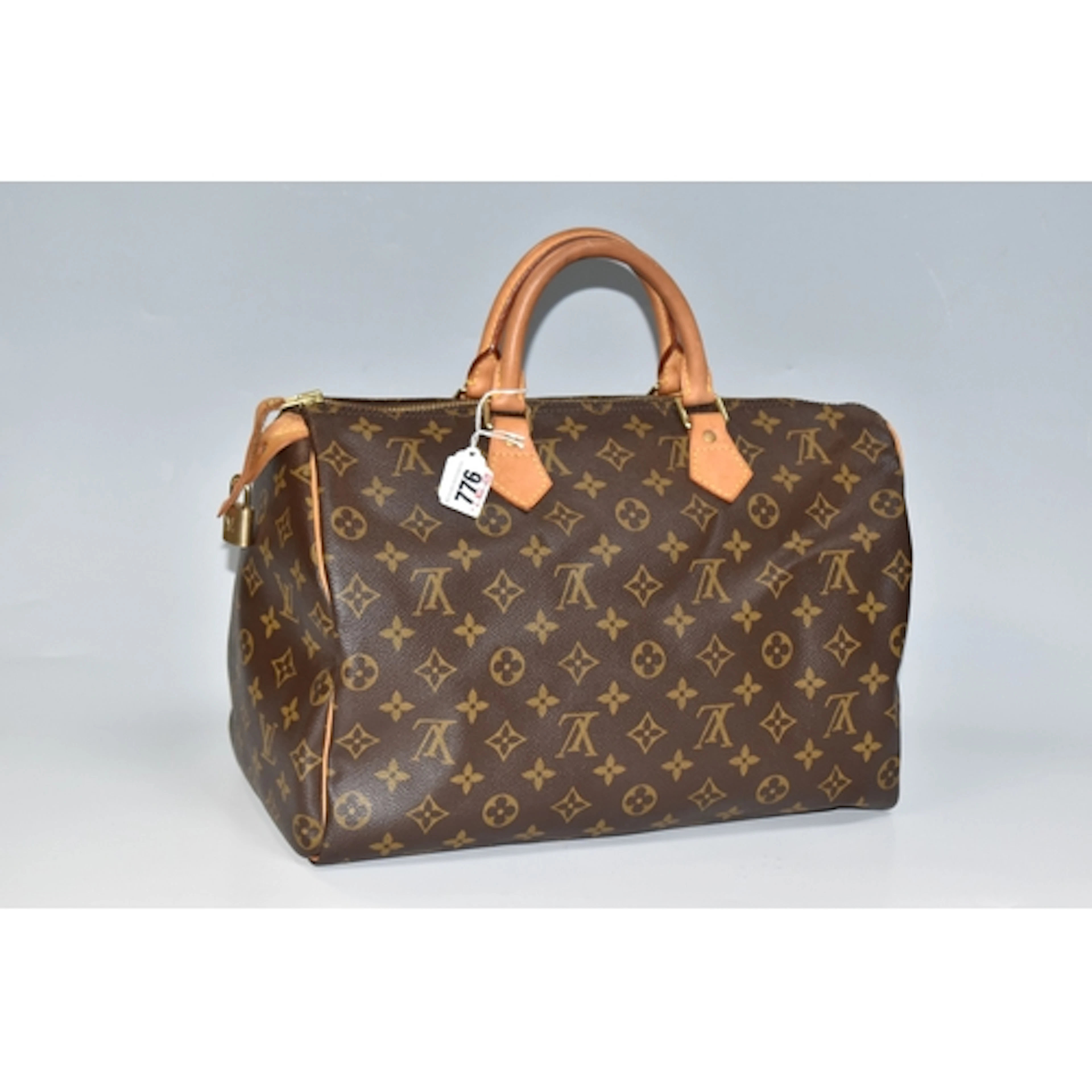 A VINTAGE LOUIS VUITTON MONOGRAM SPEEDY 30 BAG, crafted fro...