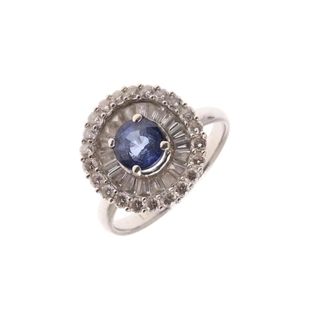 A SAPPHIRE AND DIAMOND CLUSTER RING. the oval-shaped sapphir...