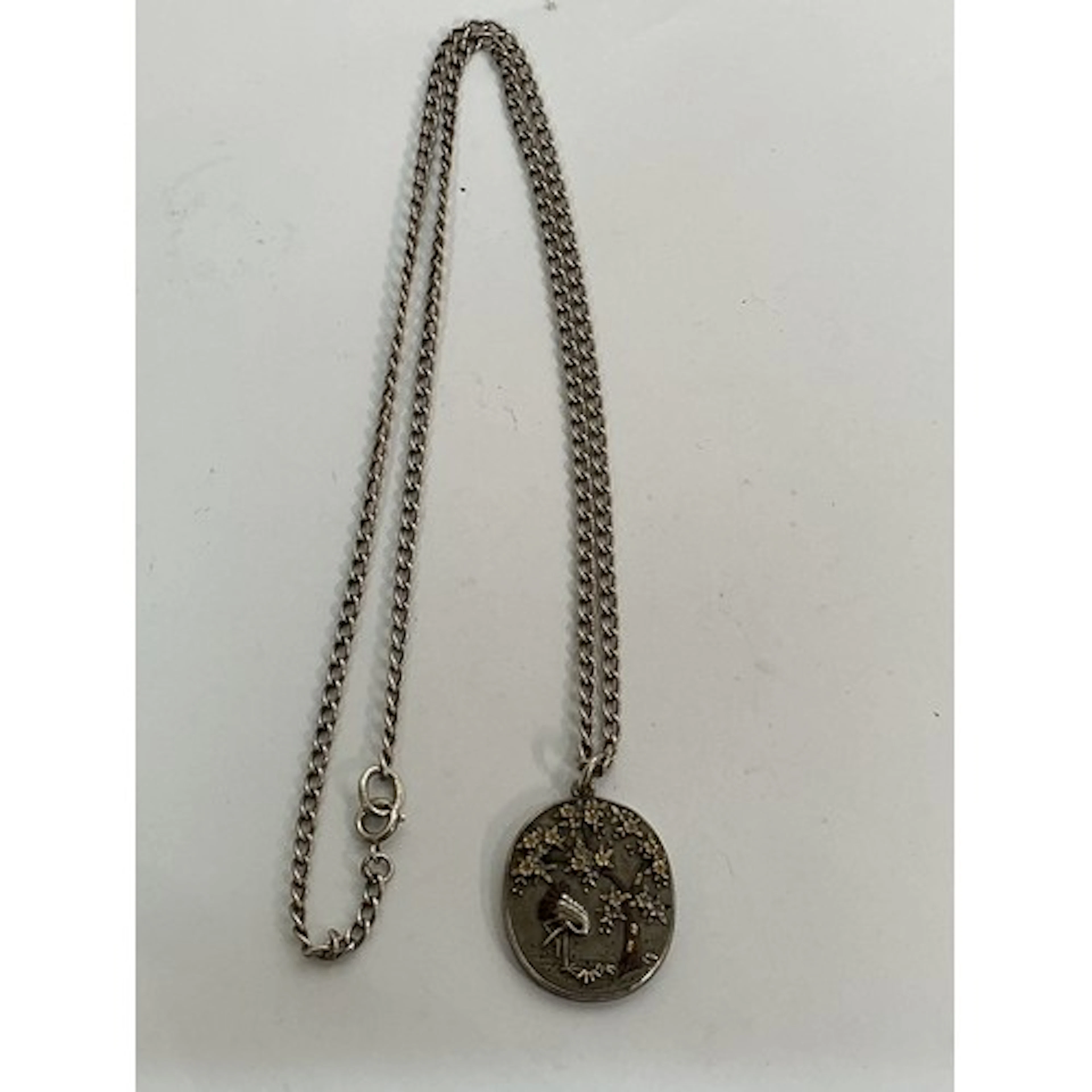 A Japanese style pendant necklace decorated in relief with a...