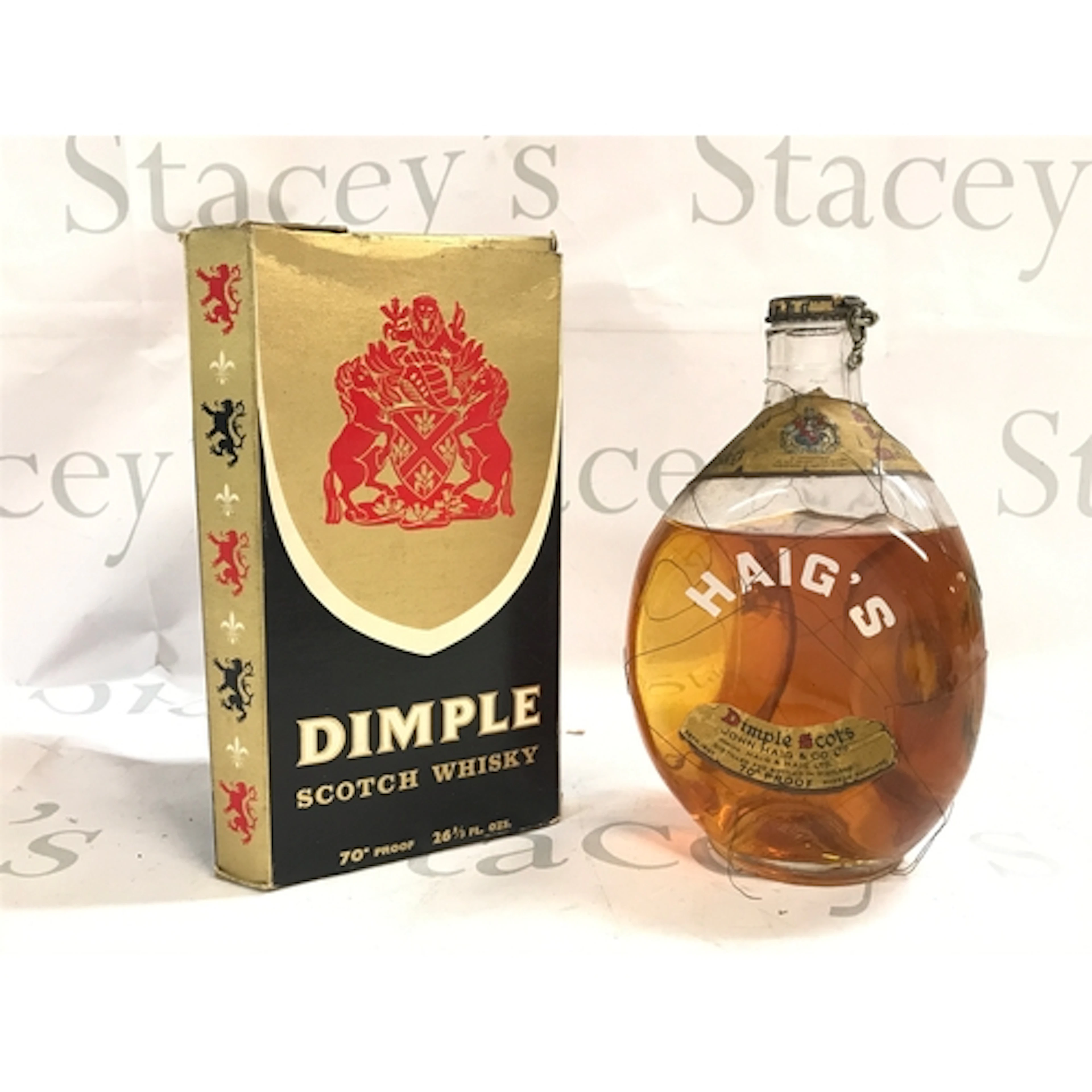 A bottle of boxed vintage Dimple scotch whiskey and a bottle...