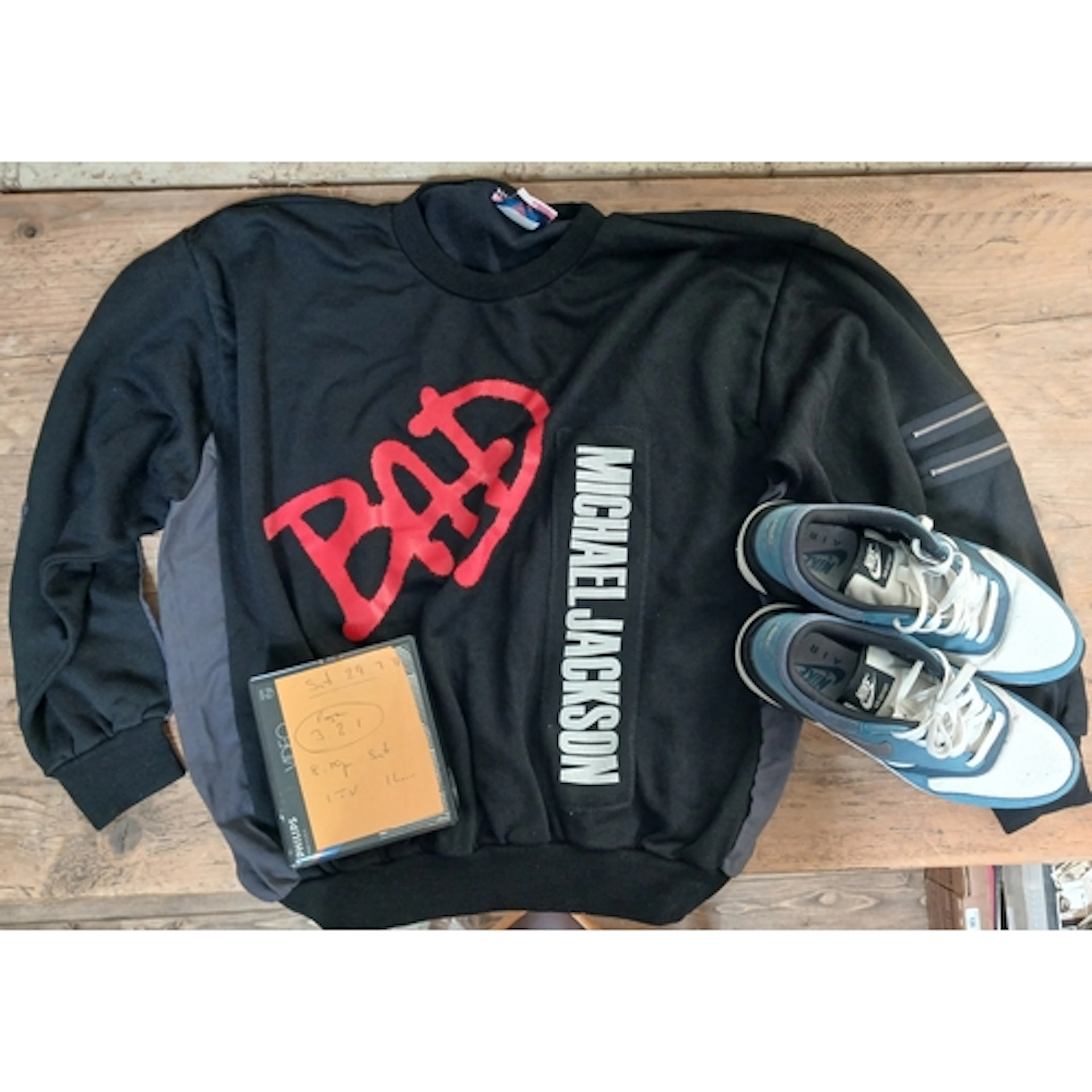 A mixed lot comprising a Michael Jackson Bad sweater, a pair...