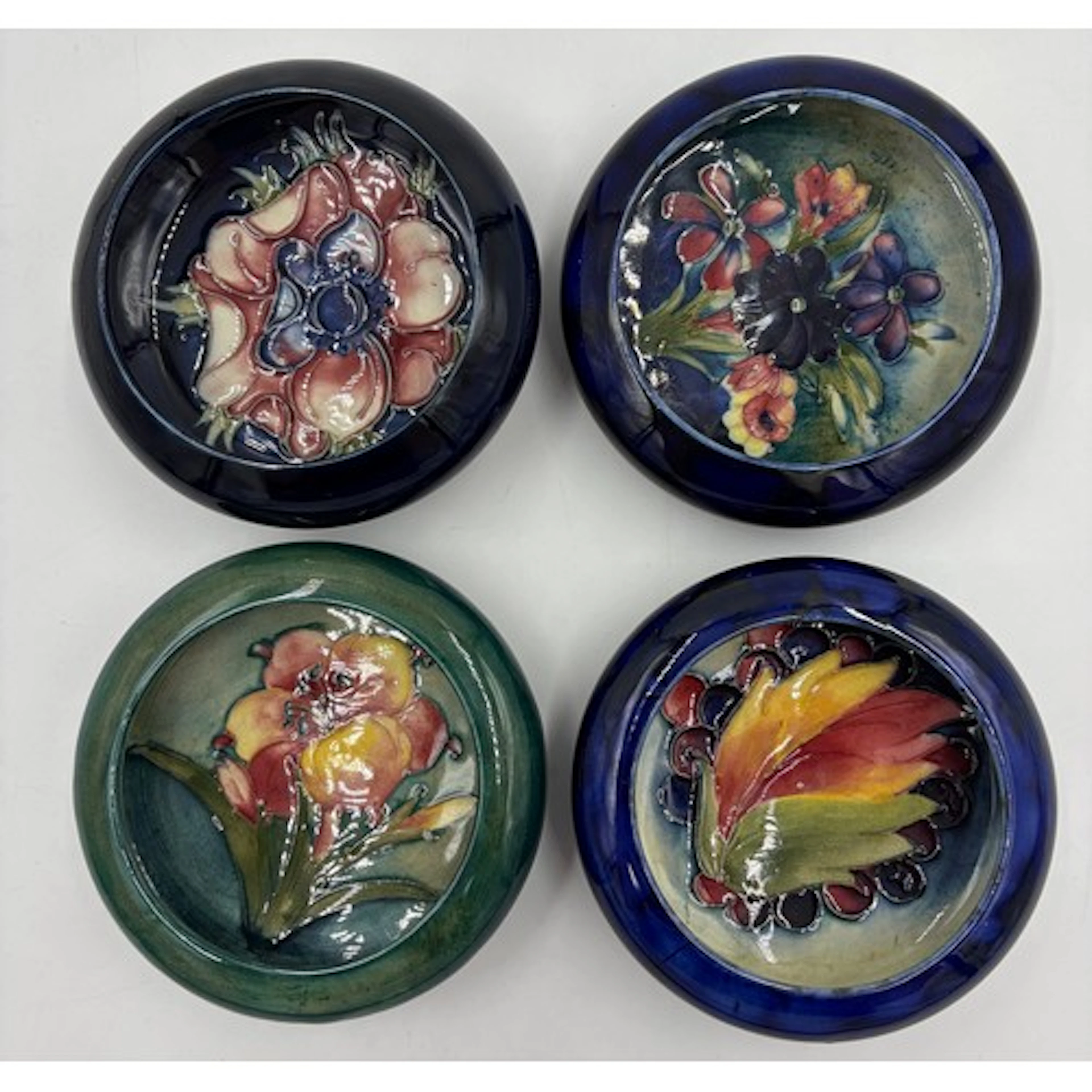 A collection of Moorcroft pottery to include 4 x small bowls...