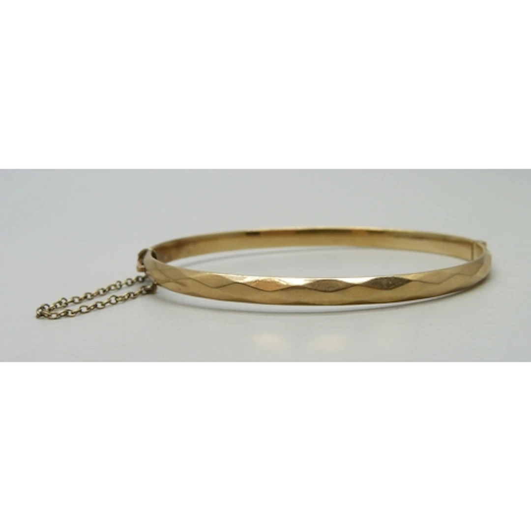 A 9ct gold 'bronze core' bangle, 11.2g