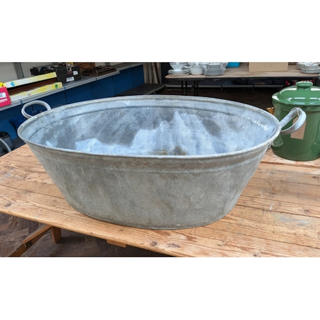 A large galvanised two handled bath or planter, 41" across h...