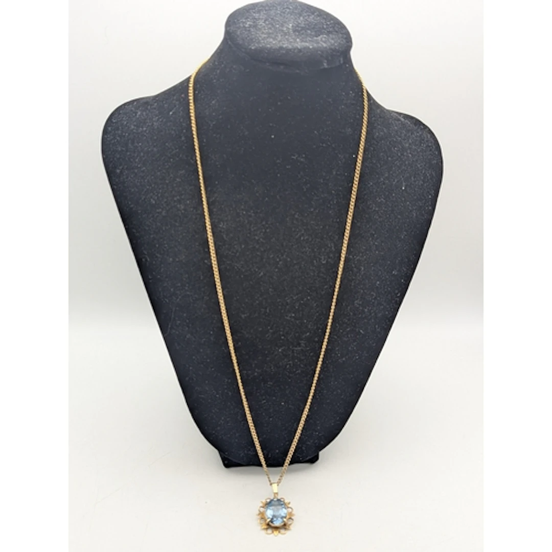 A yellow metal chain link necklace having a spring ring clas...