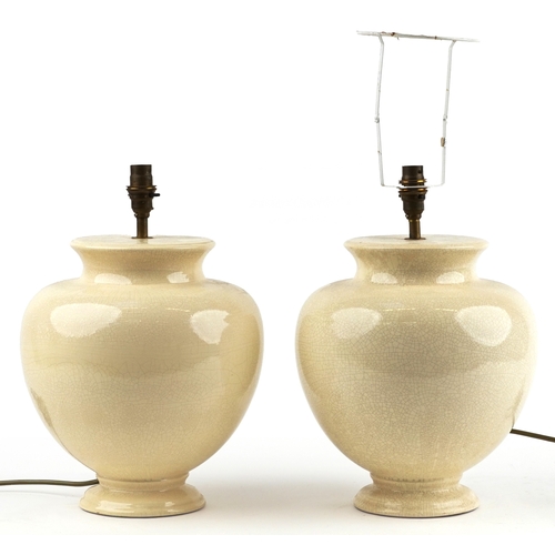 A pair of Valsan cream crackle glazed porcelain table lamps,...