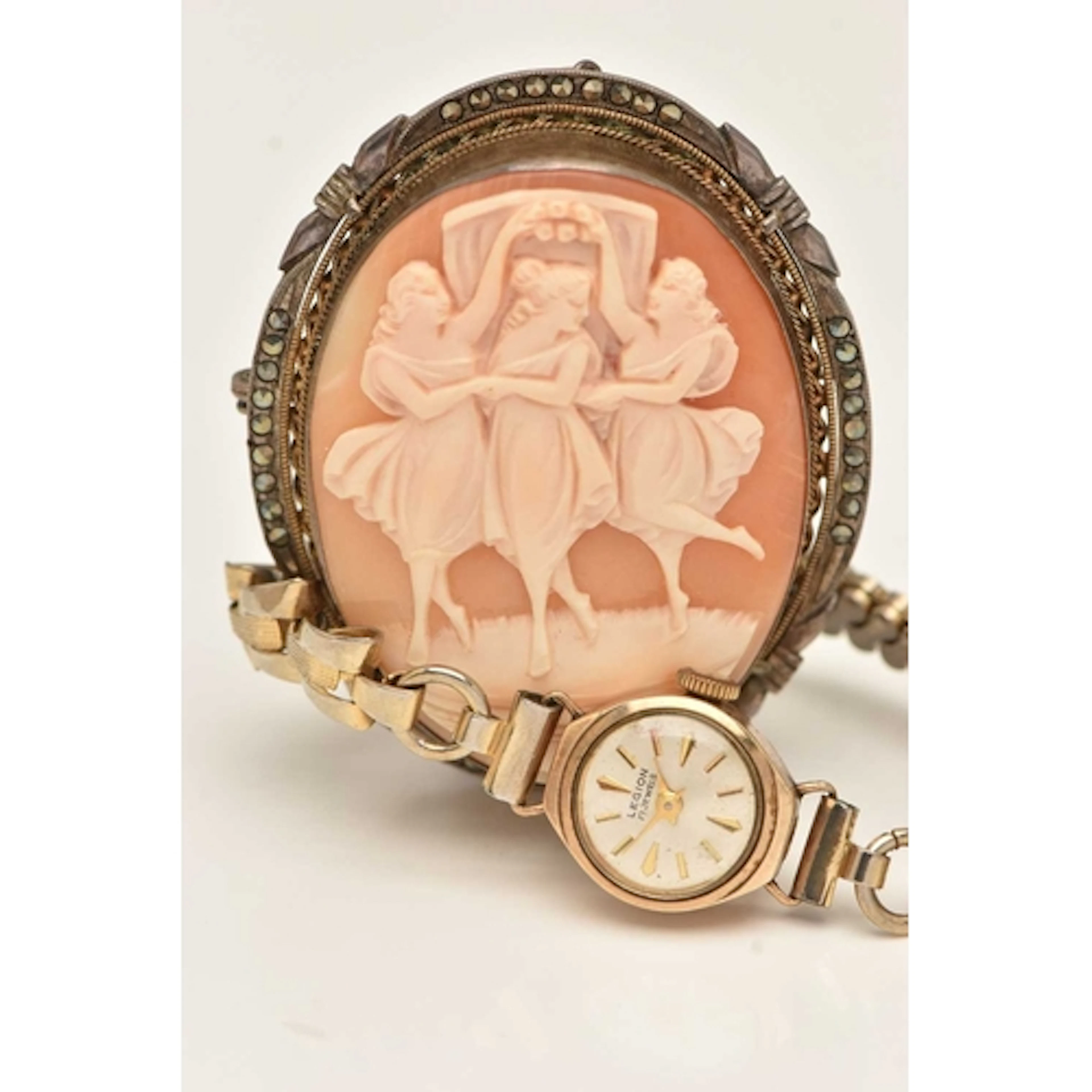 A LADIES 9CT GOLD CASED WRISTWATCH AND A CAMEO BROOCH, manua...