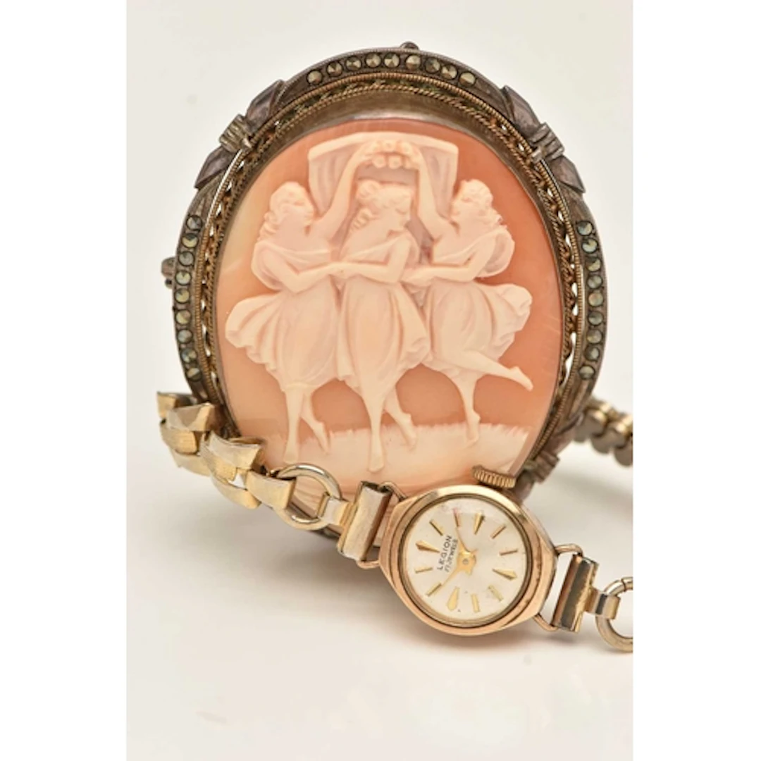 A LADIES 9CT GOLD CASED WRISTWATCH AND A CAMEO BROOCH, manua...