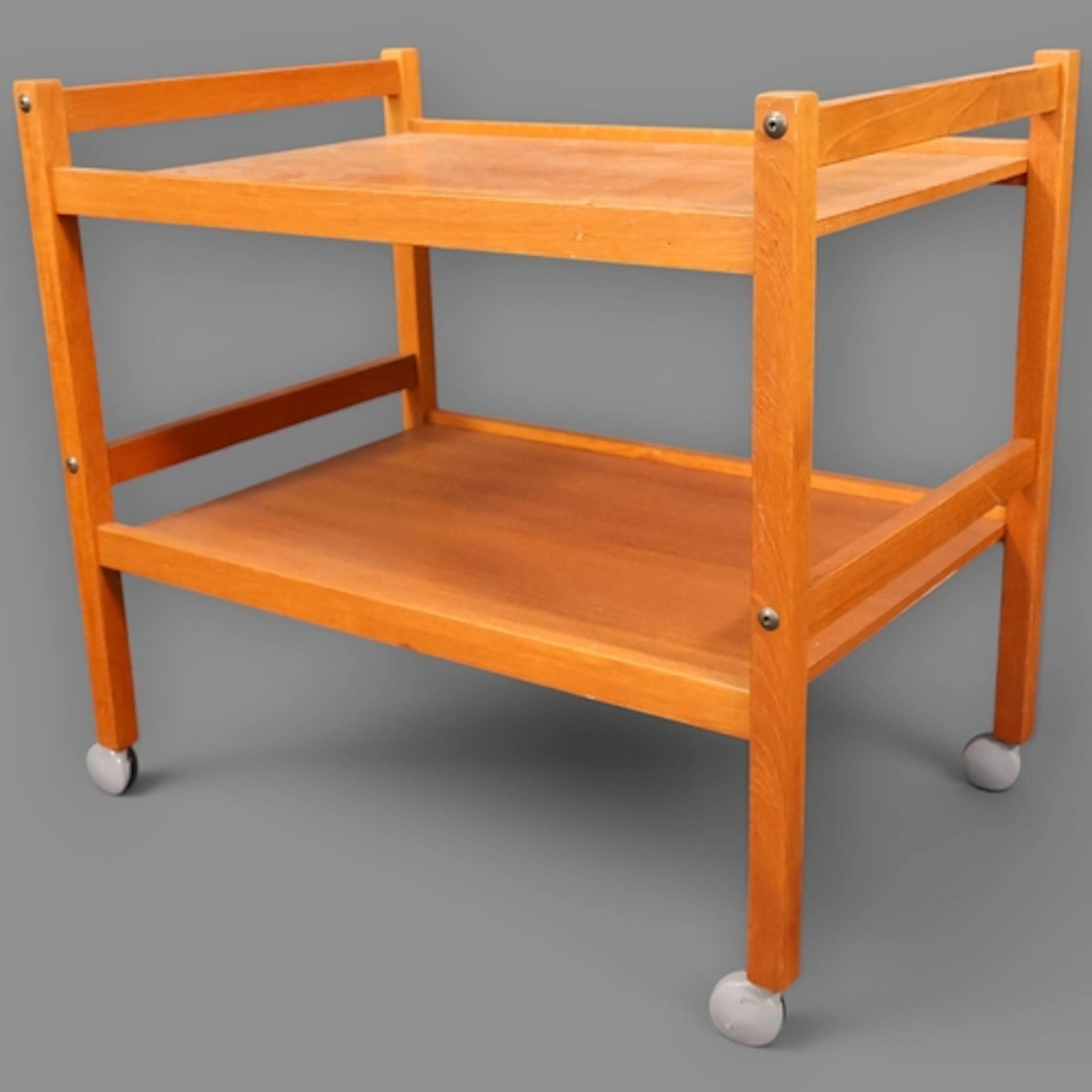 A Vintage Danish teak two tier drinks trolley on castors lab...