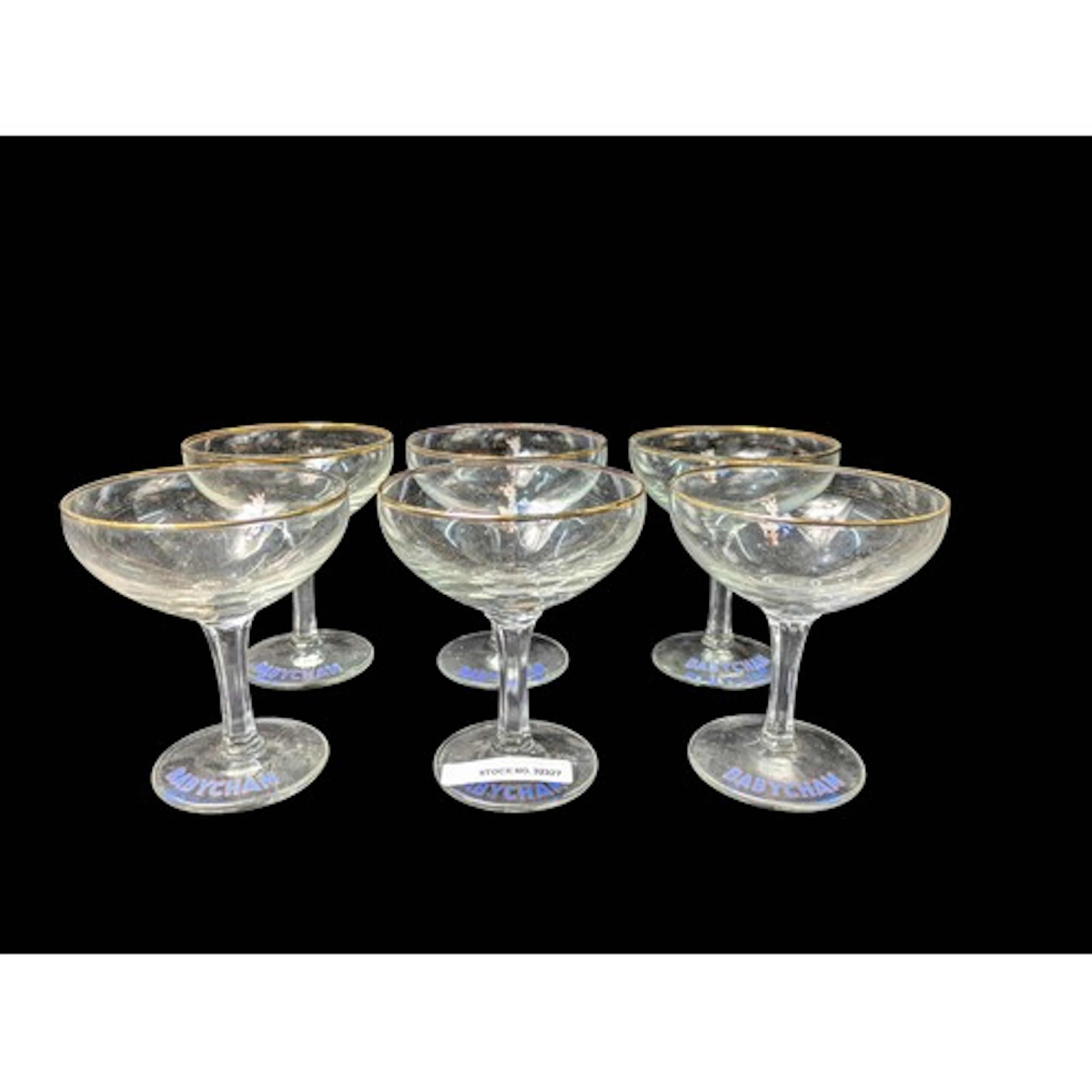 A set of Babycham advertising coupe glasses with gilt rims, ...
