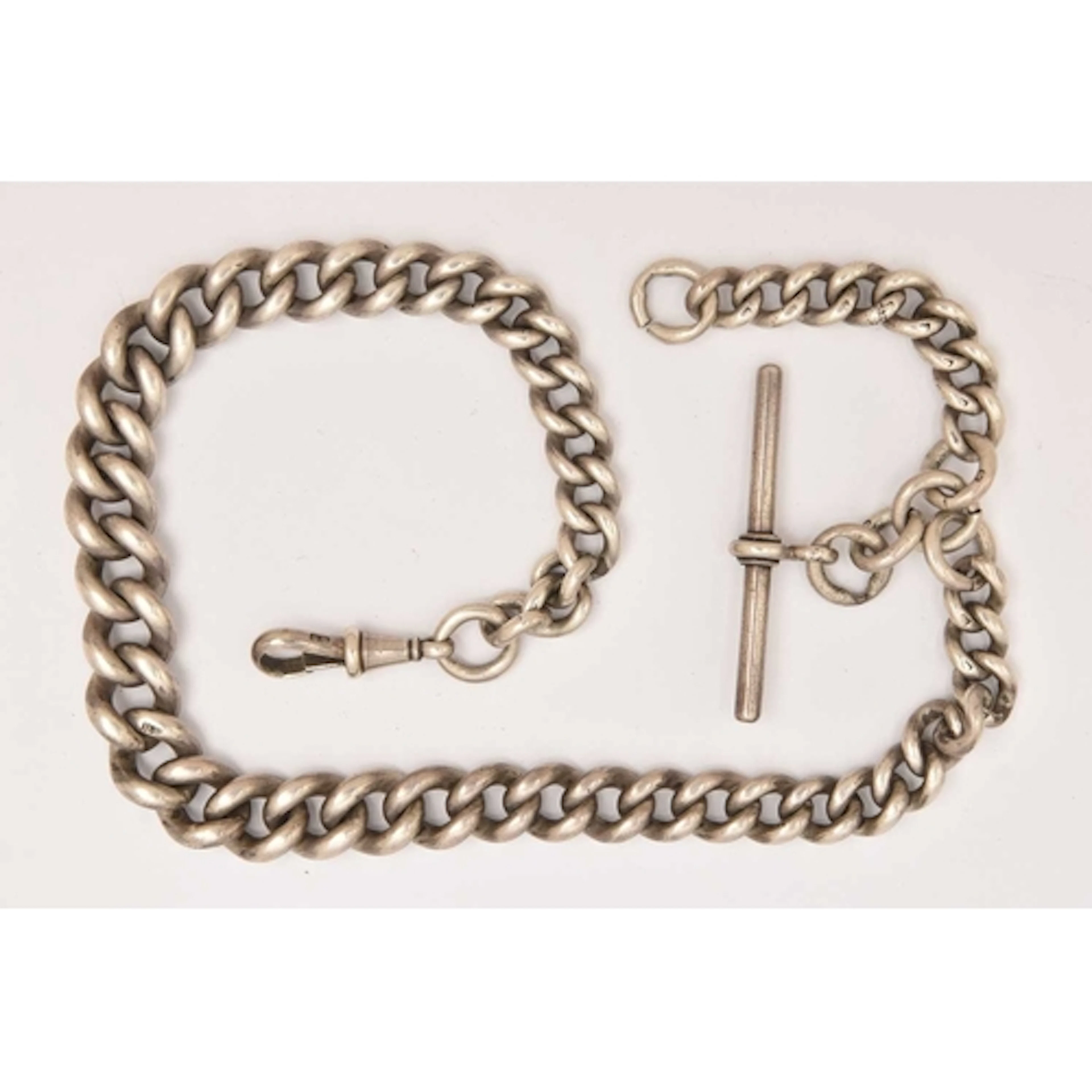 A GRADUATED SILVER ALBERT CHAIN, graduated curb links, each ...