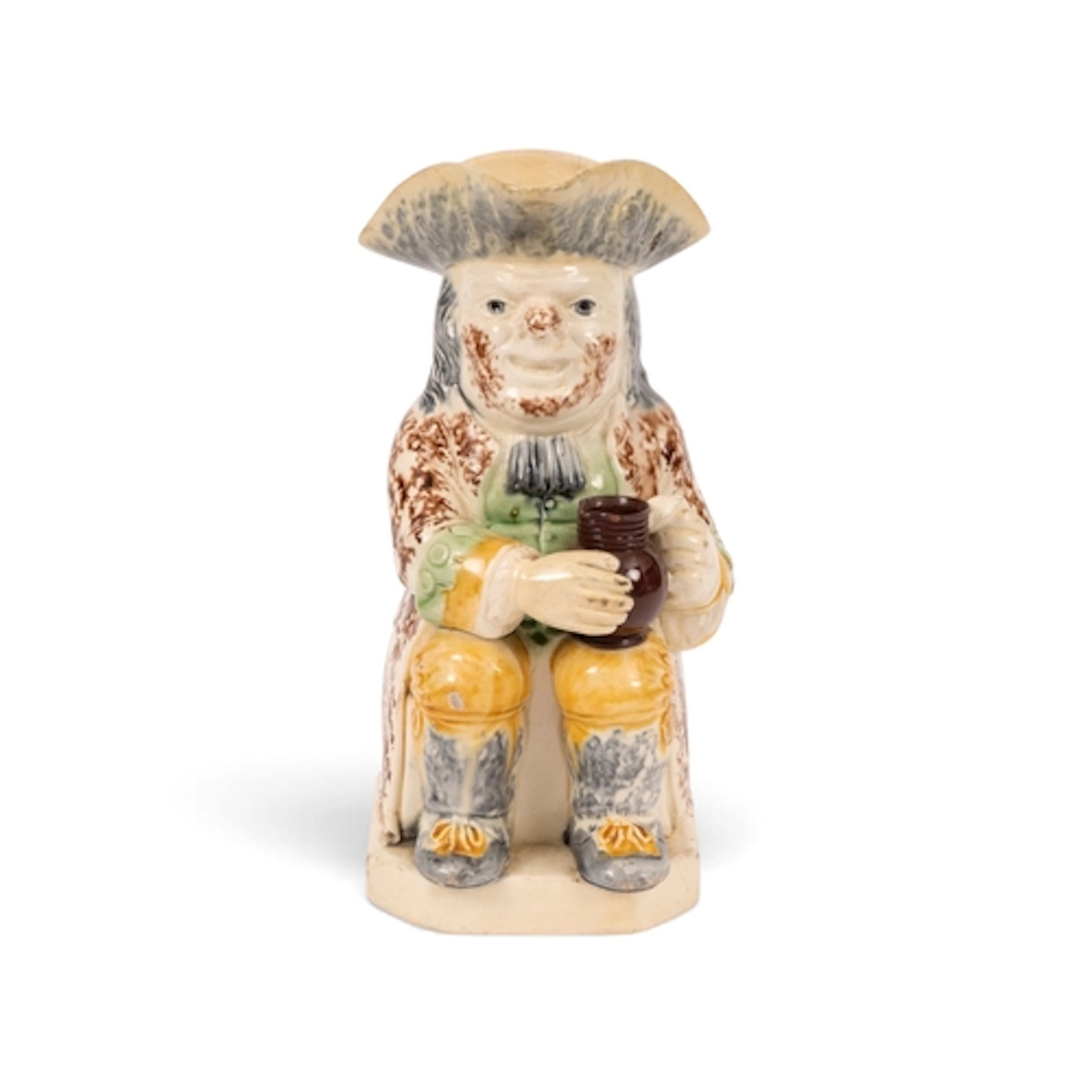 A creamware Wood type Toby jug, c.1785-90, wearing a sponged...