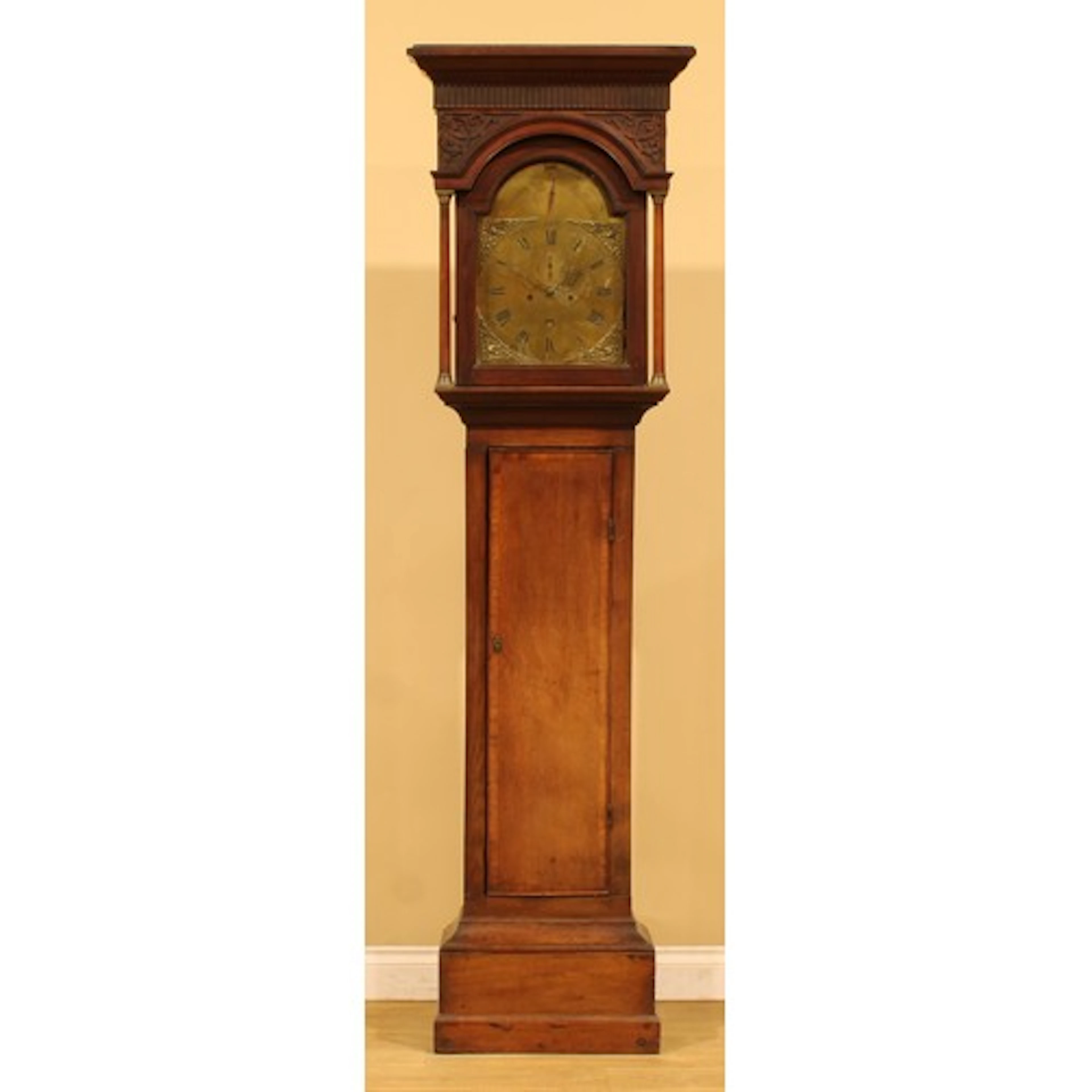 A George III oak longcase clock, 30cm arched brass dial insc...